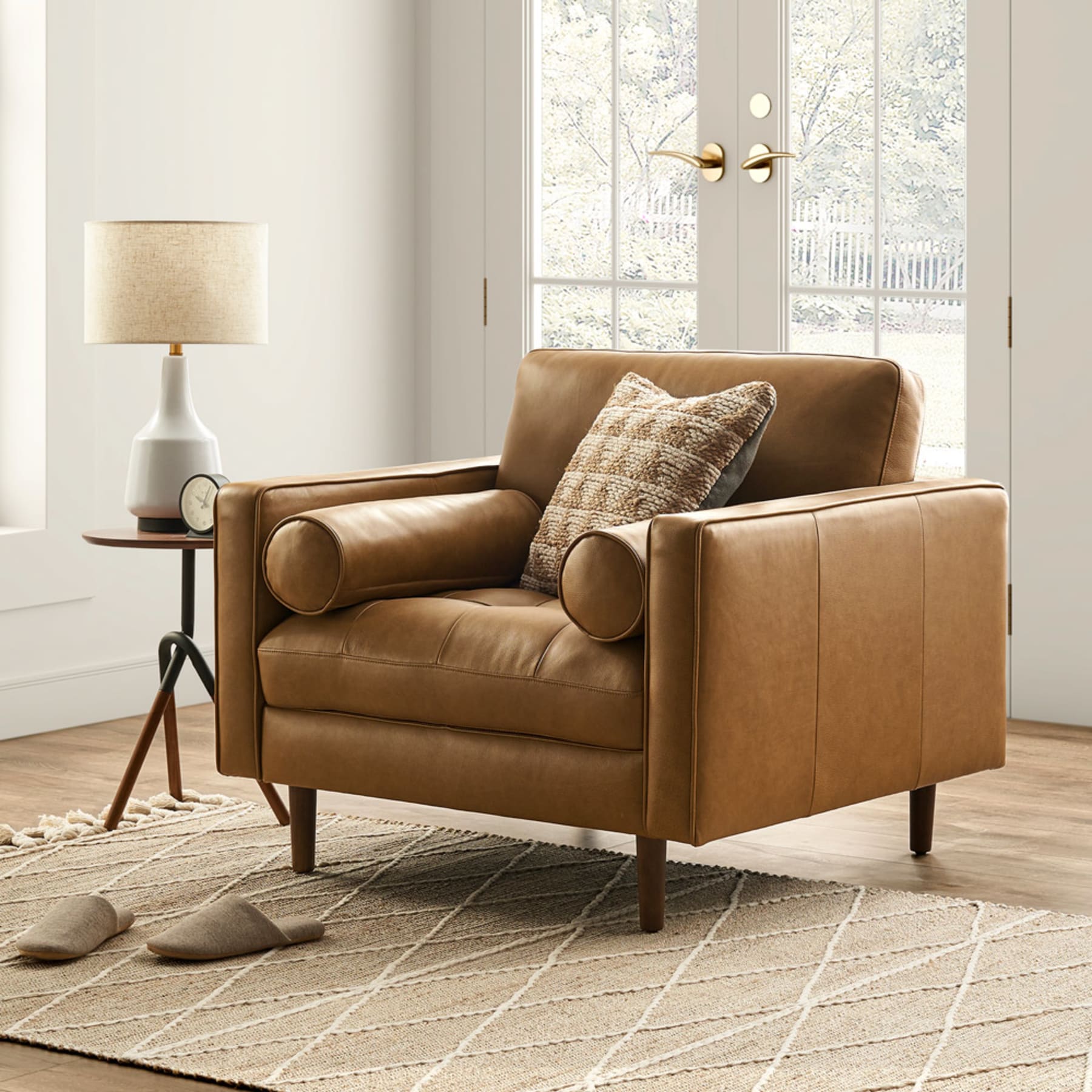 Mid-century modern leather armchair styled with an earthy jute rug