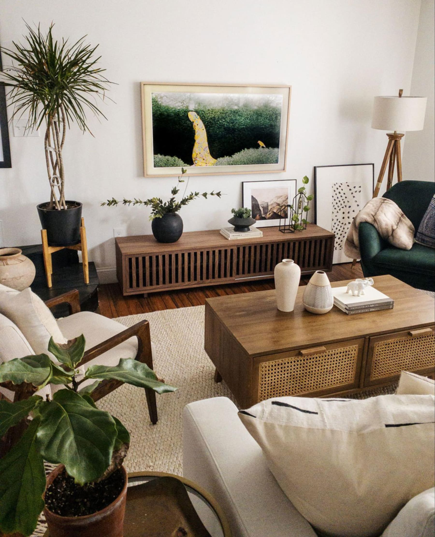 Cosy living room styled with armchairs, sofa and a mid-century tv console