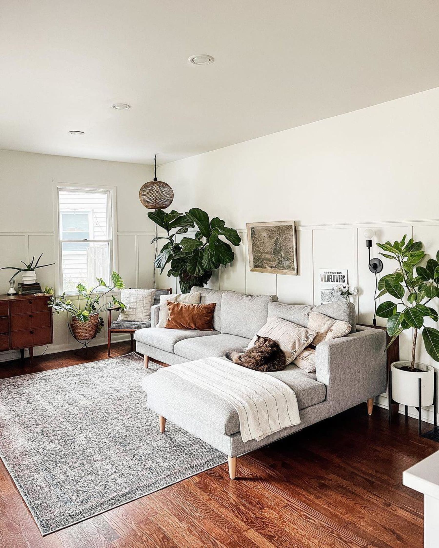 A light grey sectional sofa in an earth-toned room