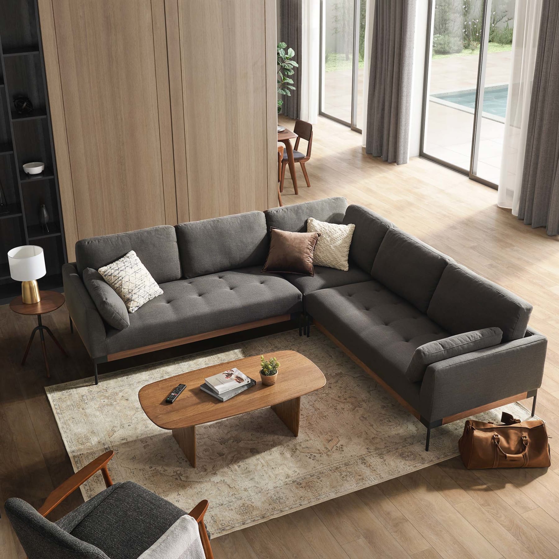 A black L-shaped sectional sofa in a living room.