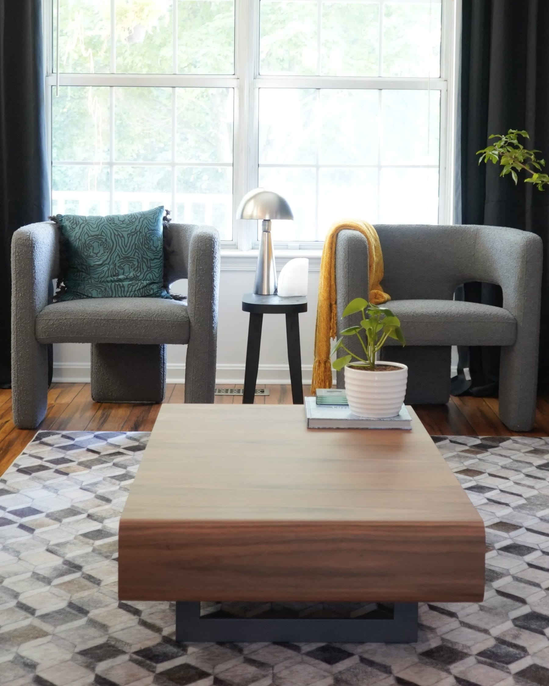 Two matching gray armchairs and a coffee table.