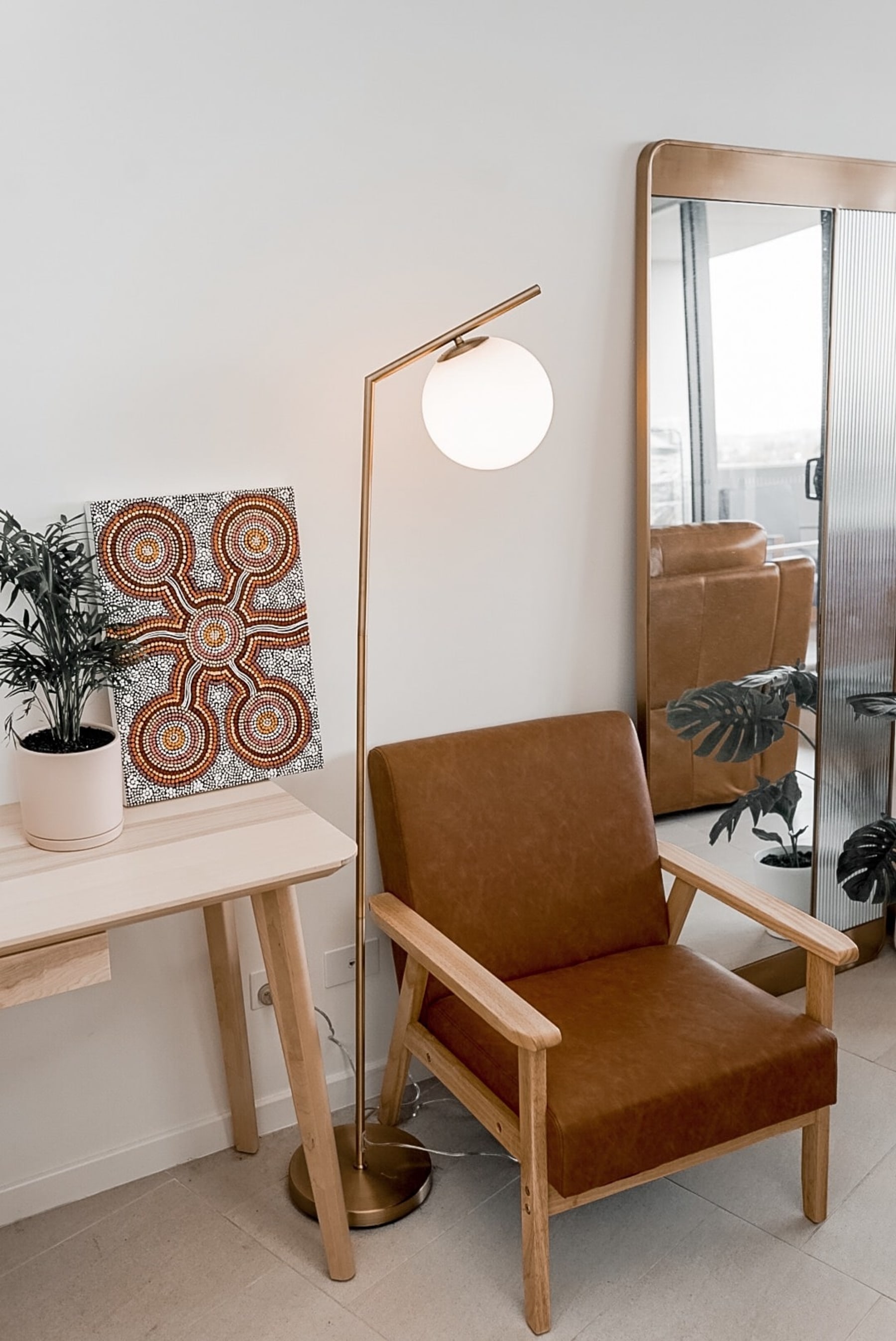 A floor lamp beside an armchair.