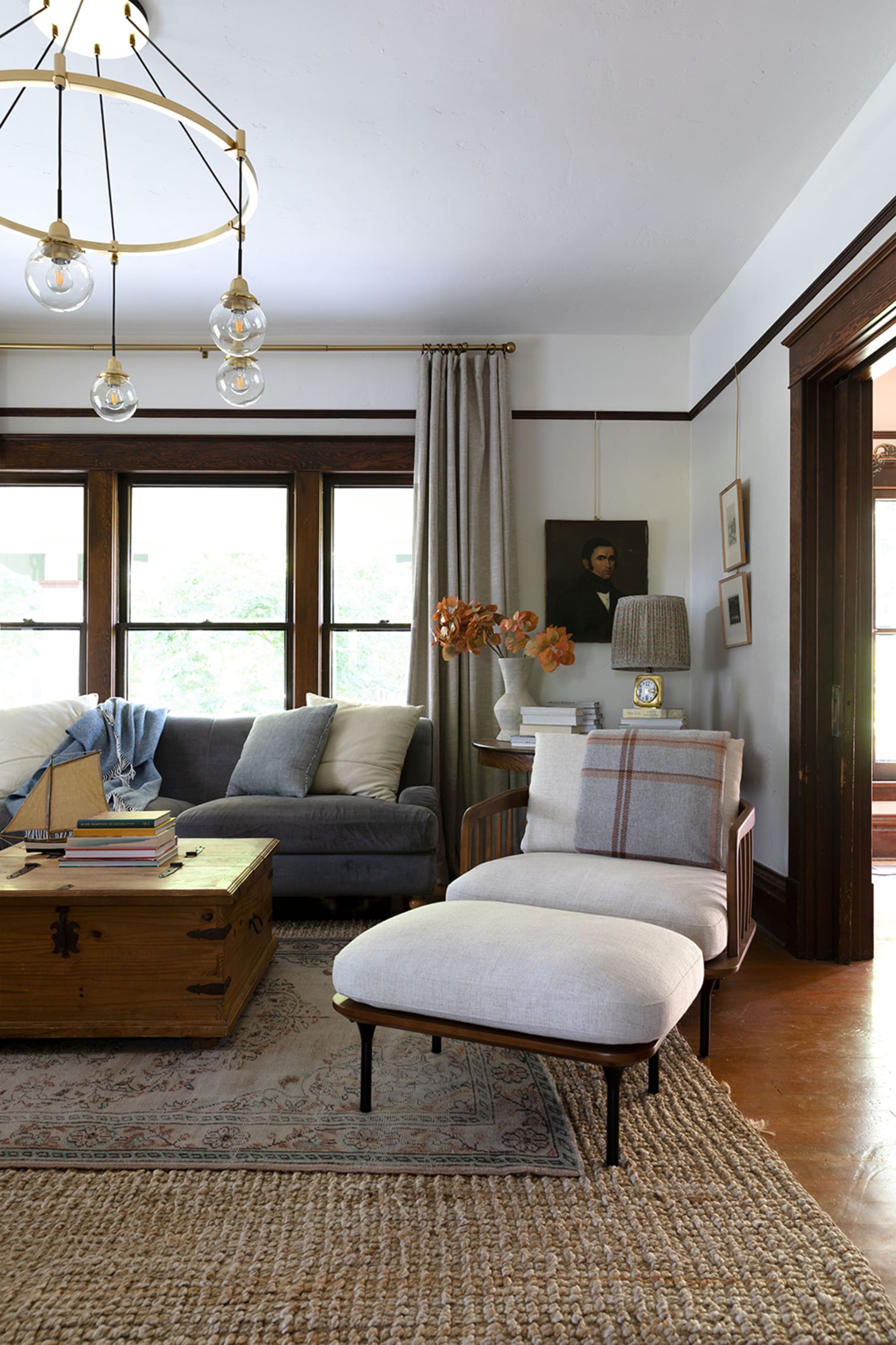 A wooden armchair and wooden chest used as a coffee table.