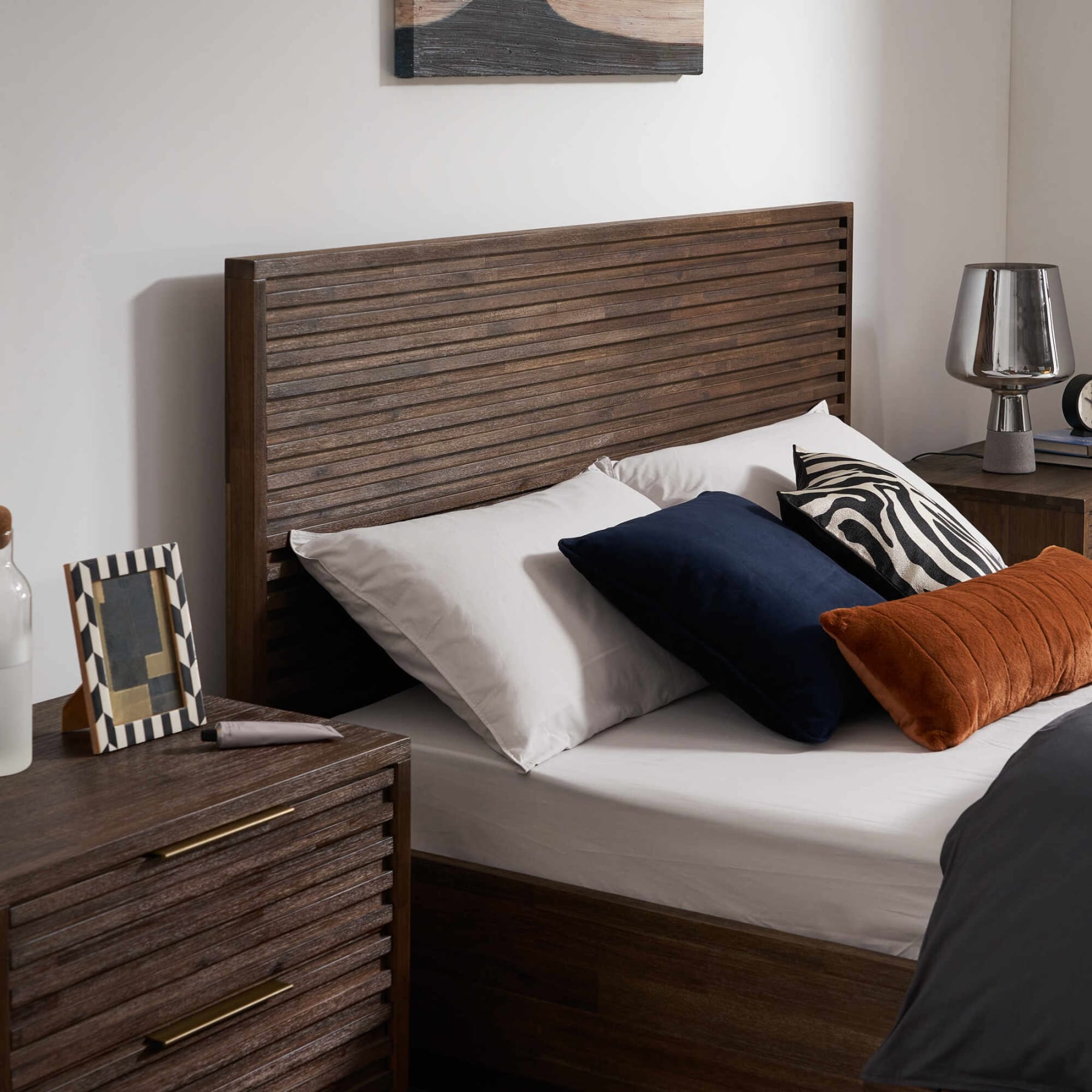 Close up of a wooden bedframe and nightstand