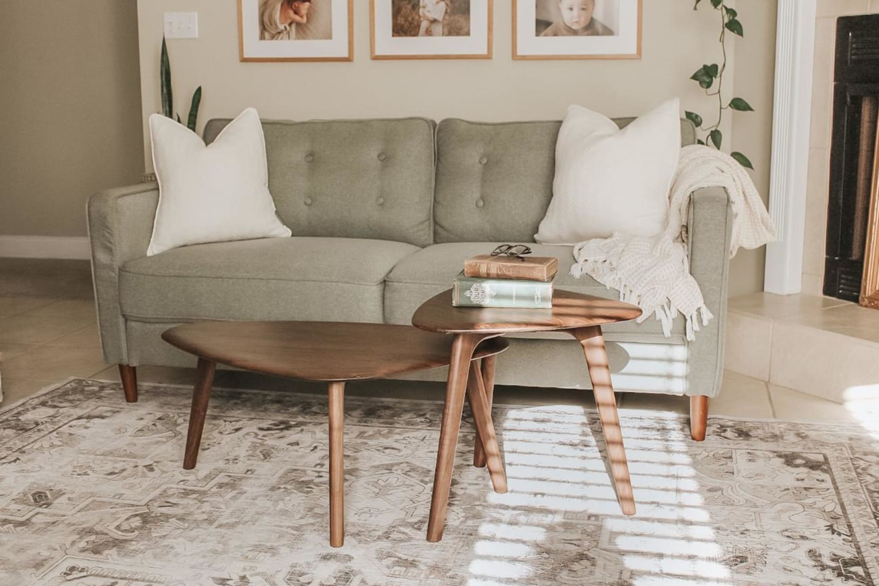 A coffee table set in a dark walnut shade complements the legs of the sofa.