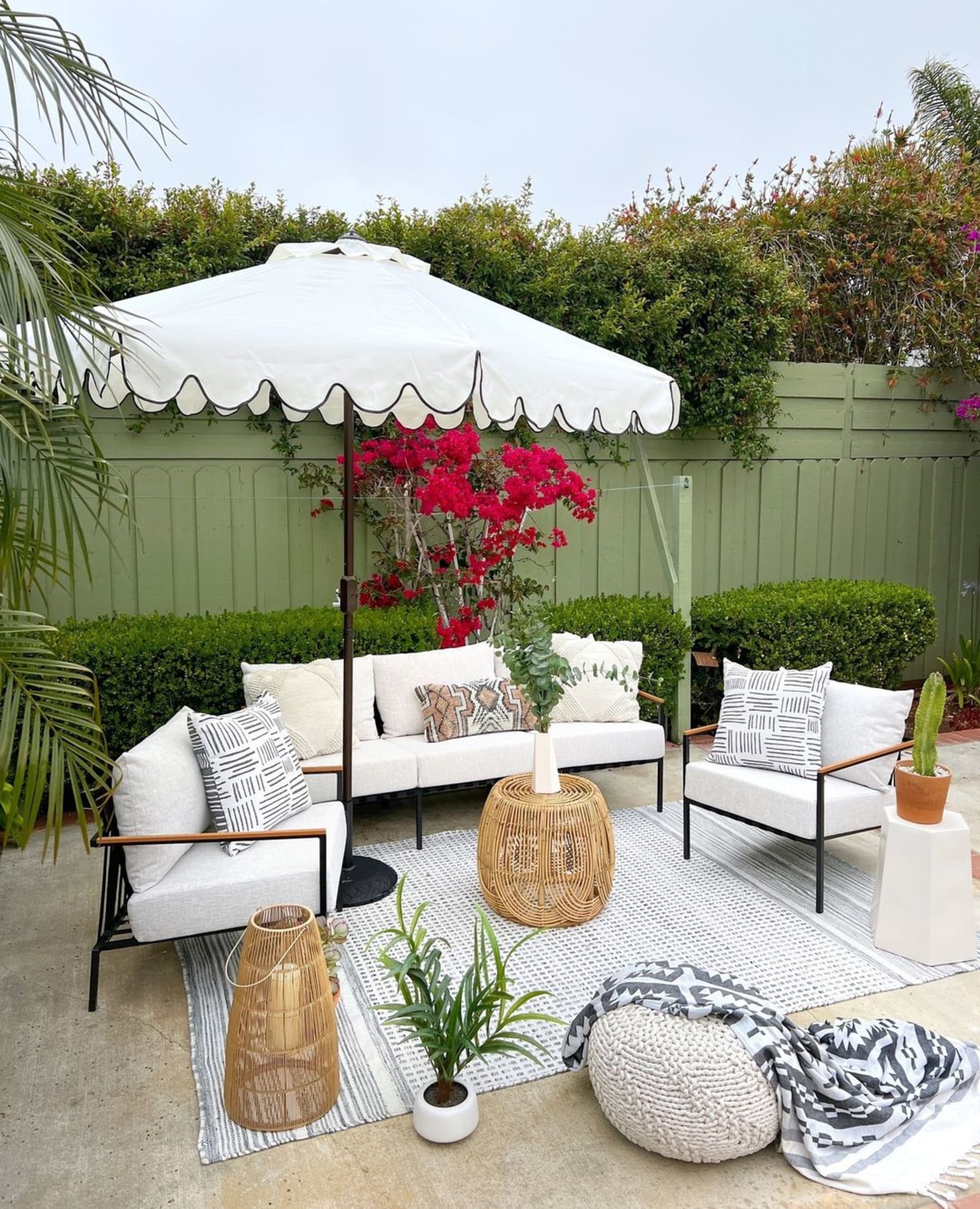 A sleek outdoor fabric lounge set that consists of a sofa and two armchairs.