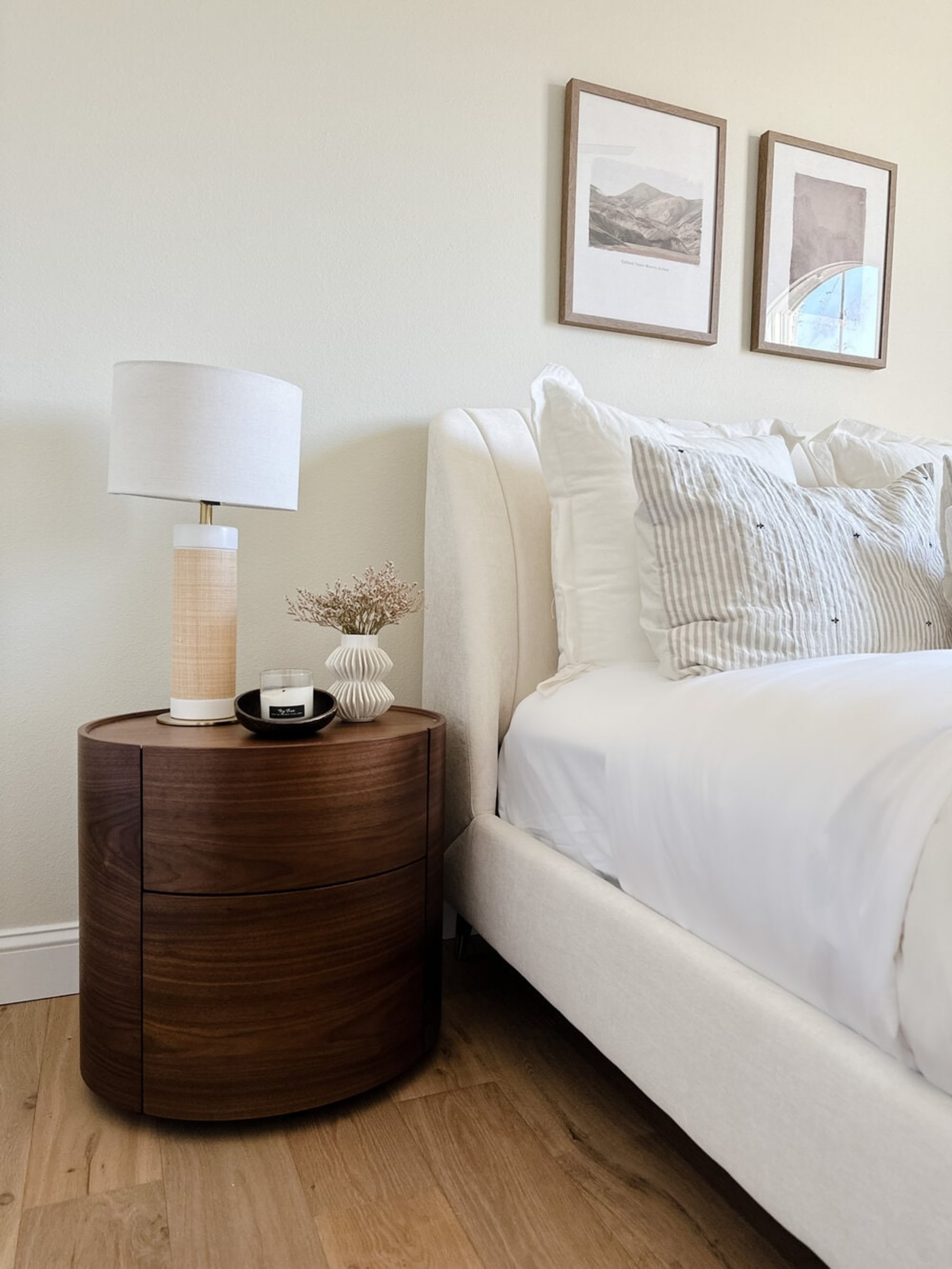 A wooden side table with its doors open has two compartments to store items.