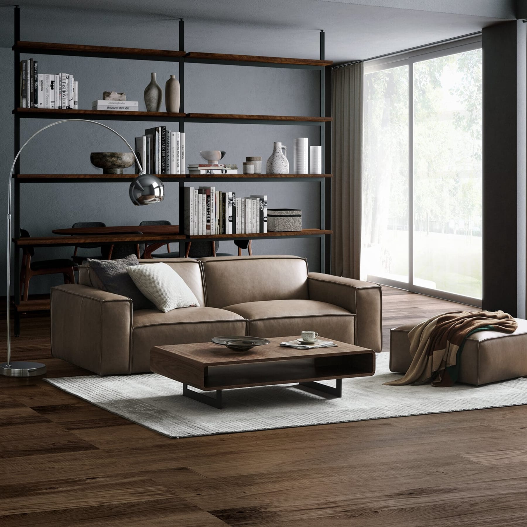 A brown leather sofa and a matching leather ottoman sit in the living room.