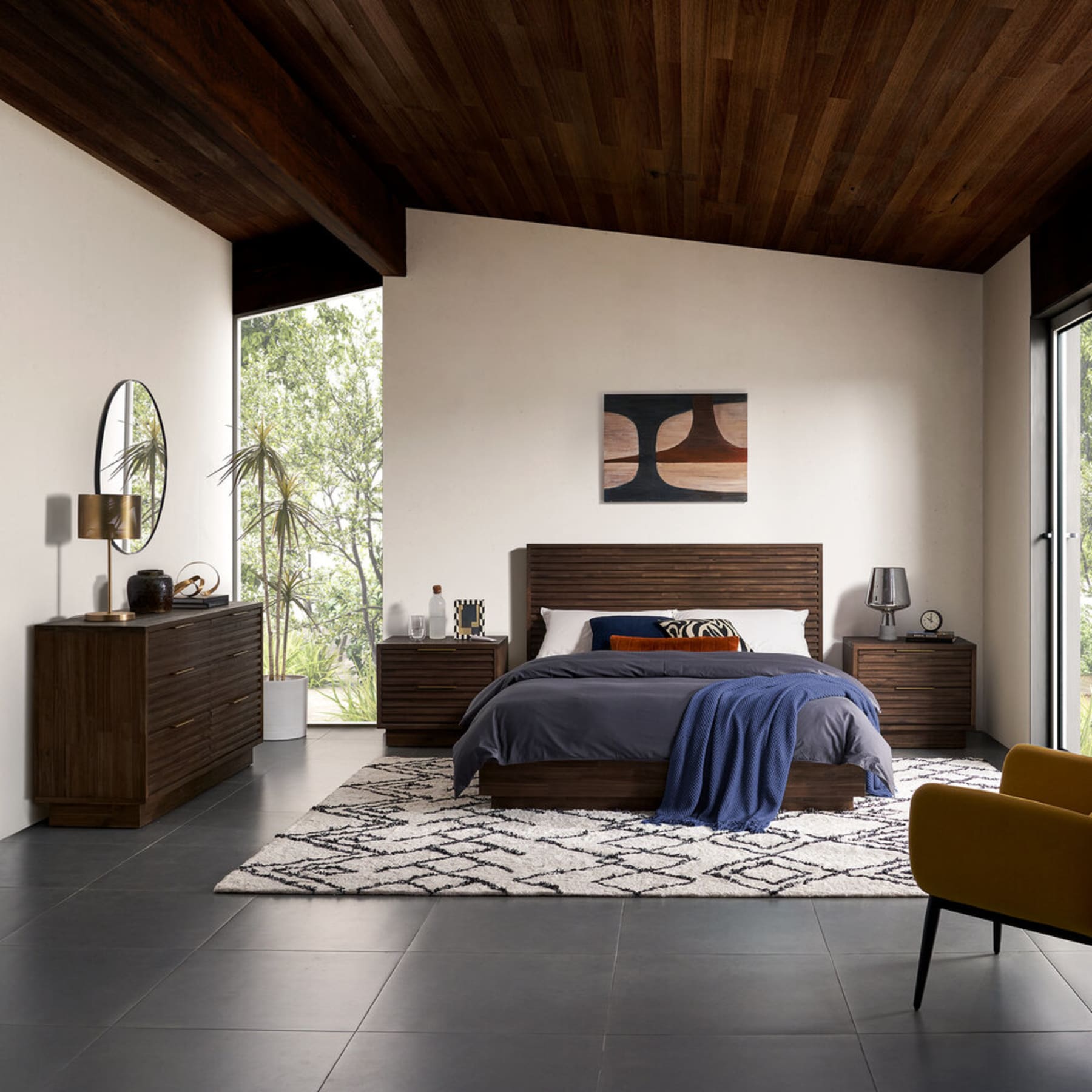 A dark walnut bedroom set that consists of a bed frame, nightstands, and a dresser.