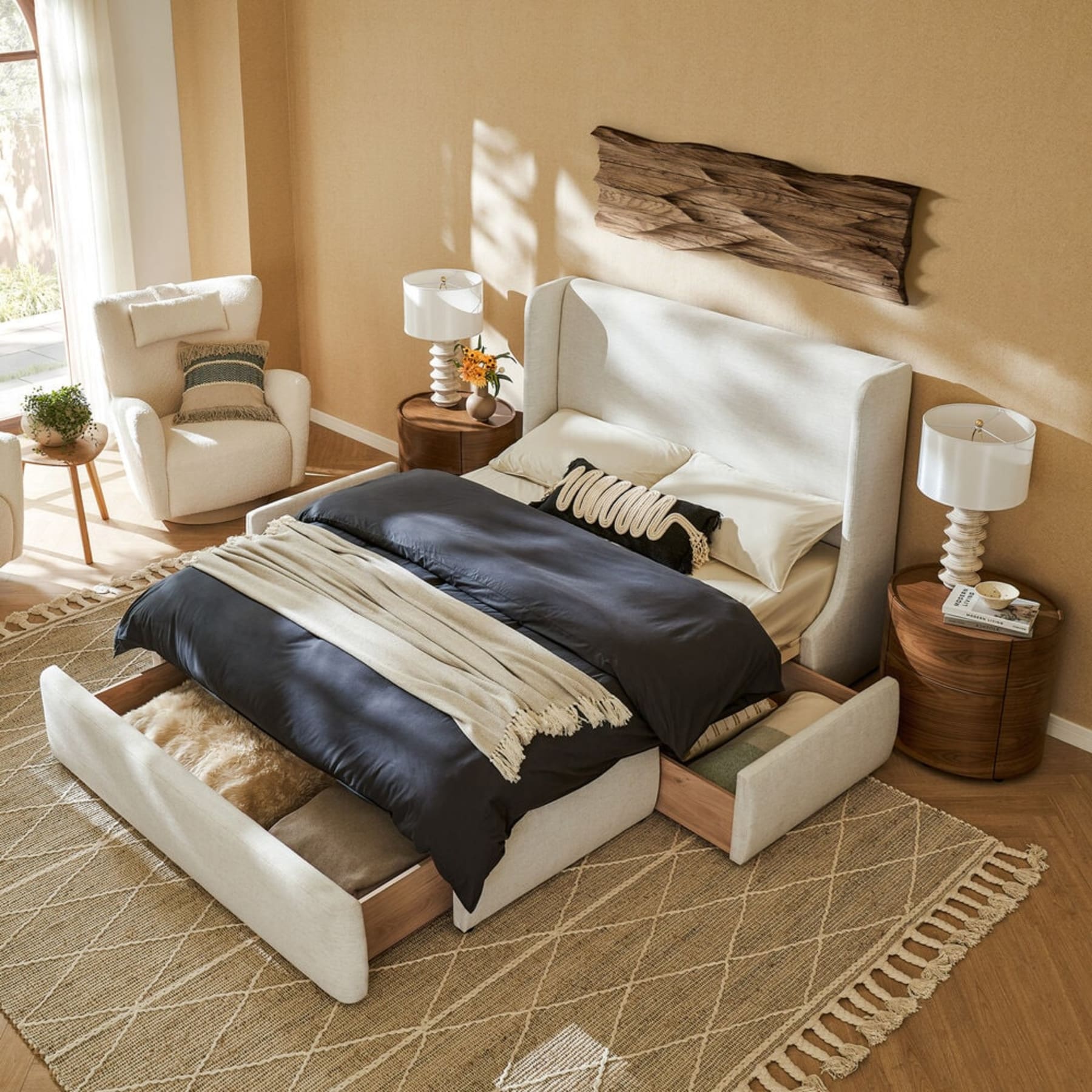 A bed with pull out storage at the bottom atop a jute rug.