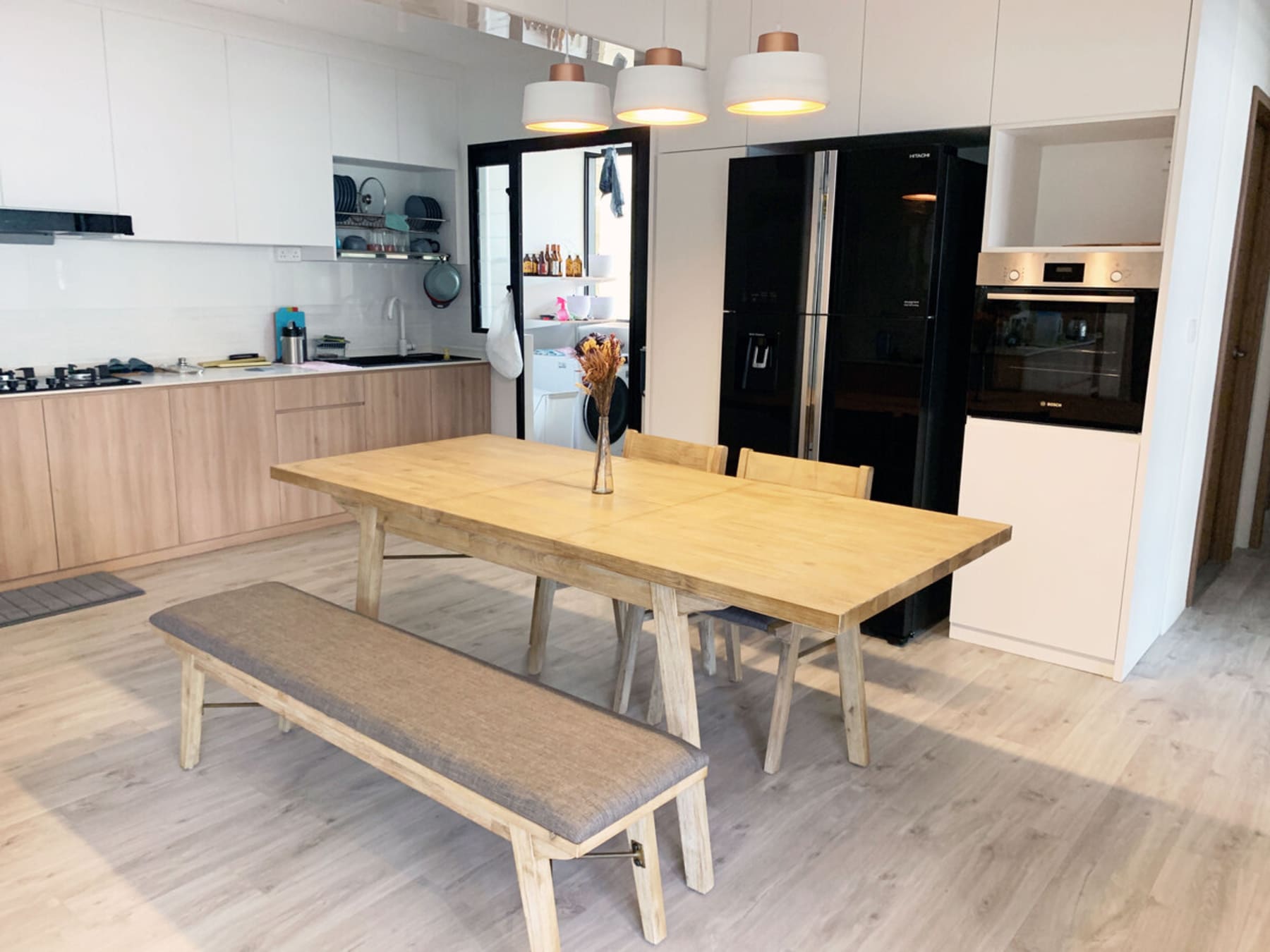 A dining table set with matching chairs and a bench made from solid acacia wood