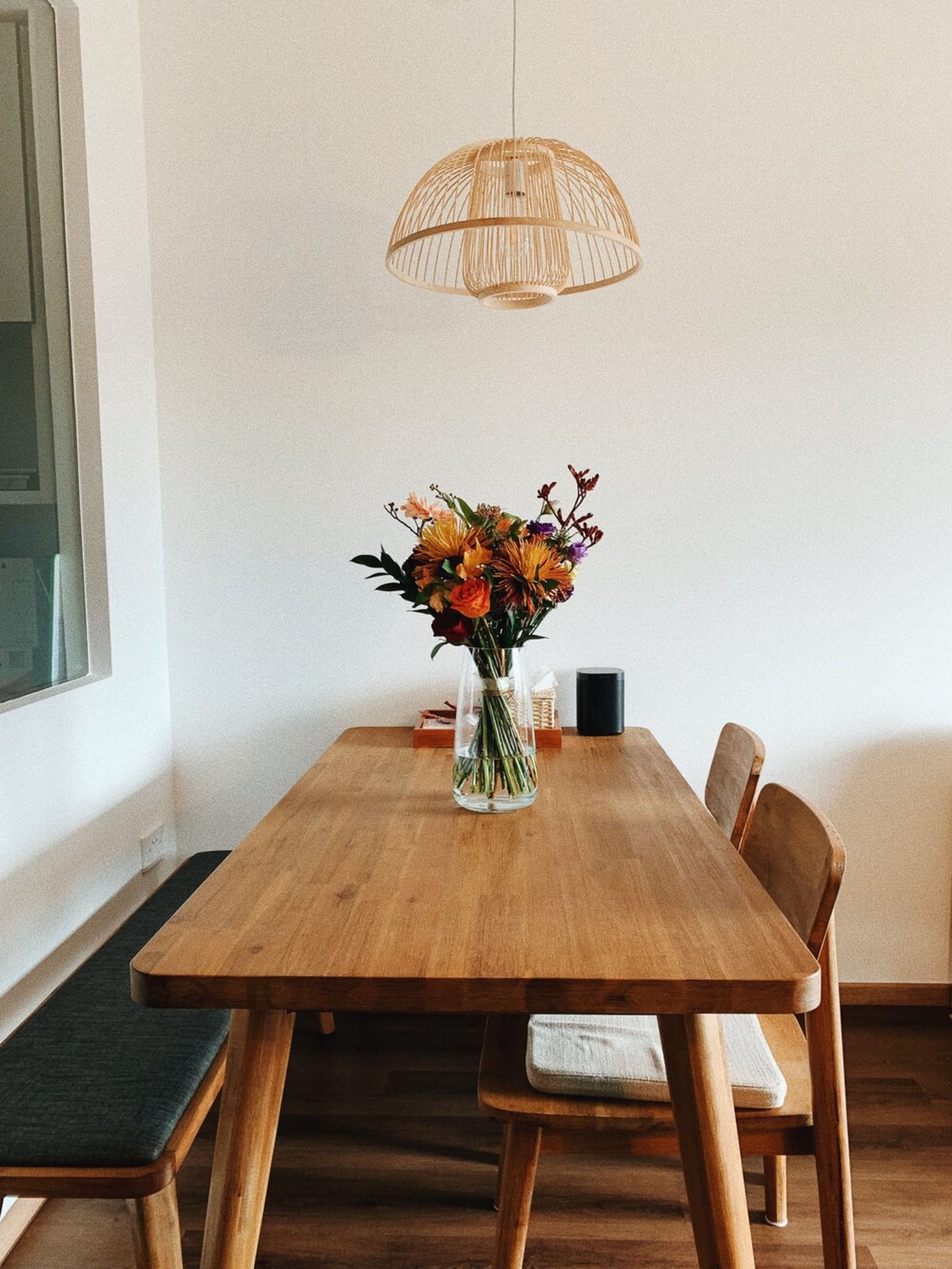 A wooden dining table with 2 matching chairs and a bench.