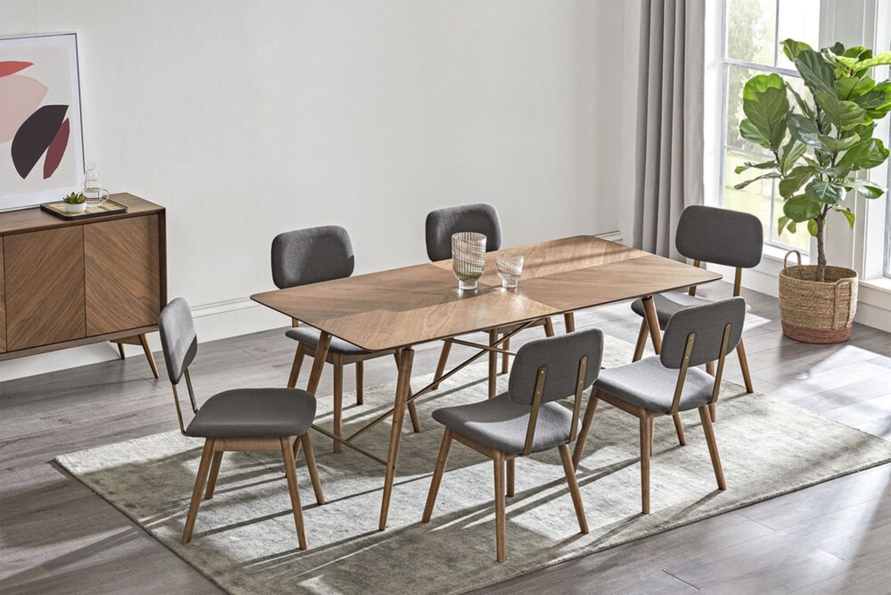 A wooden table with chevron patterns and 6 matching fabric upholstered chairs.