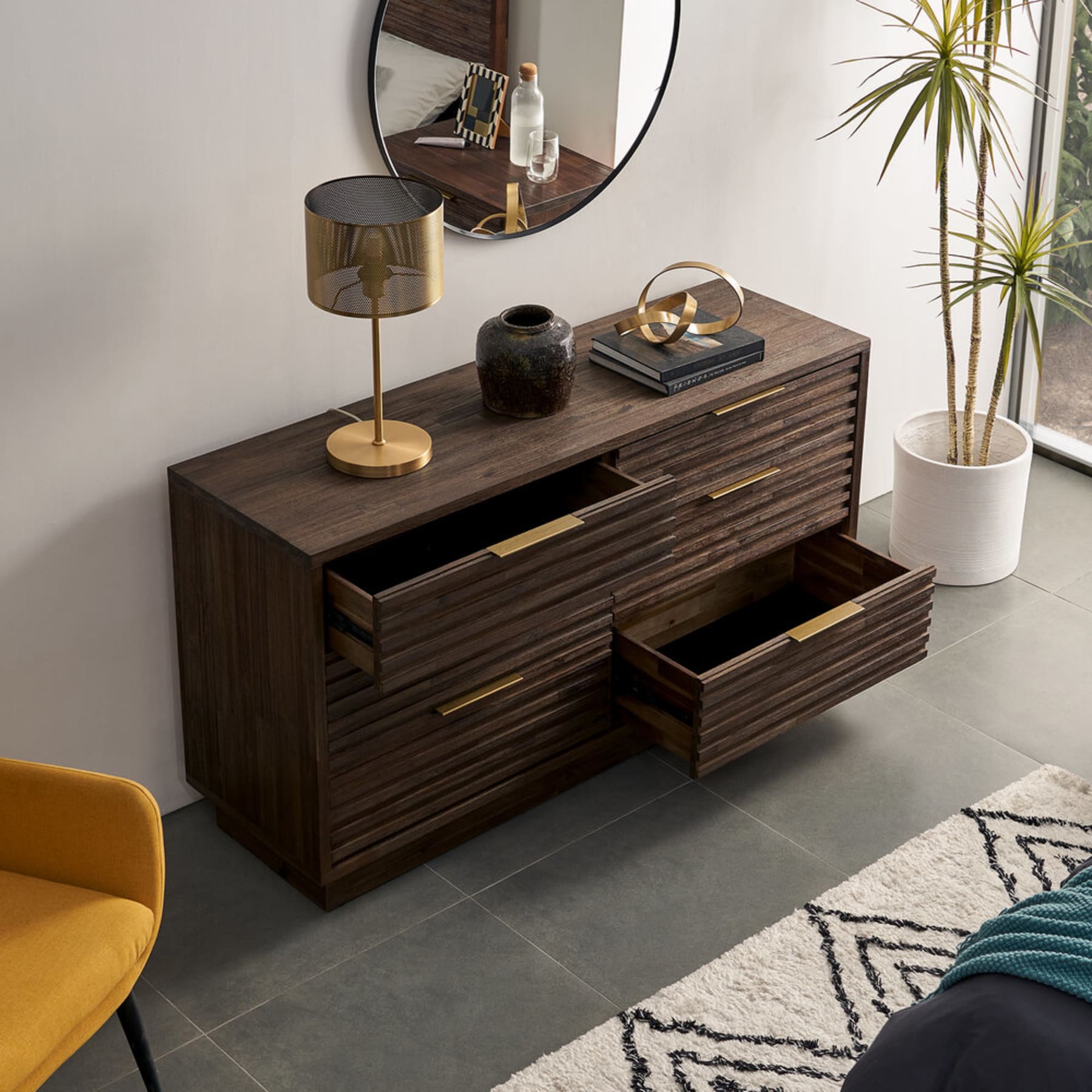 A dark walnut-stained 6-drawer dresser with fluted elements.