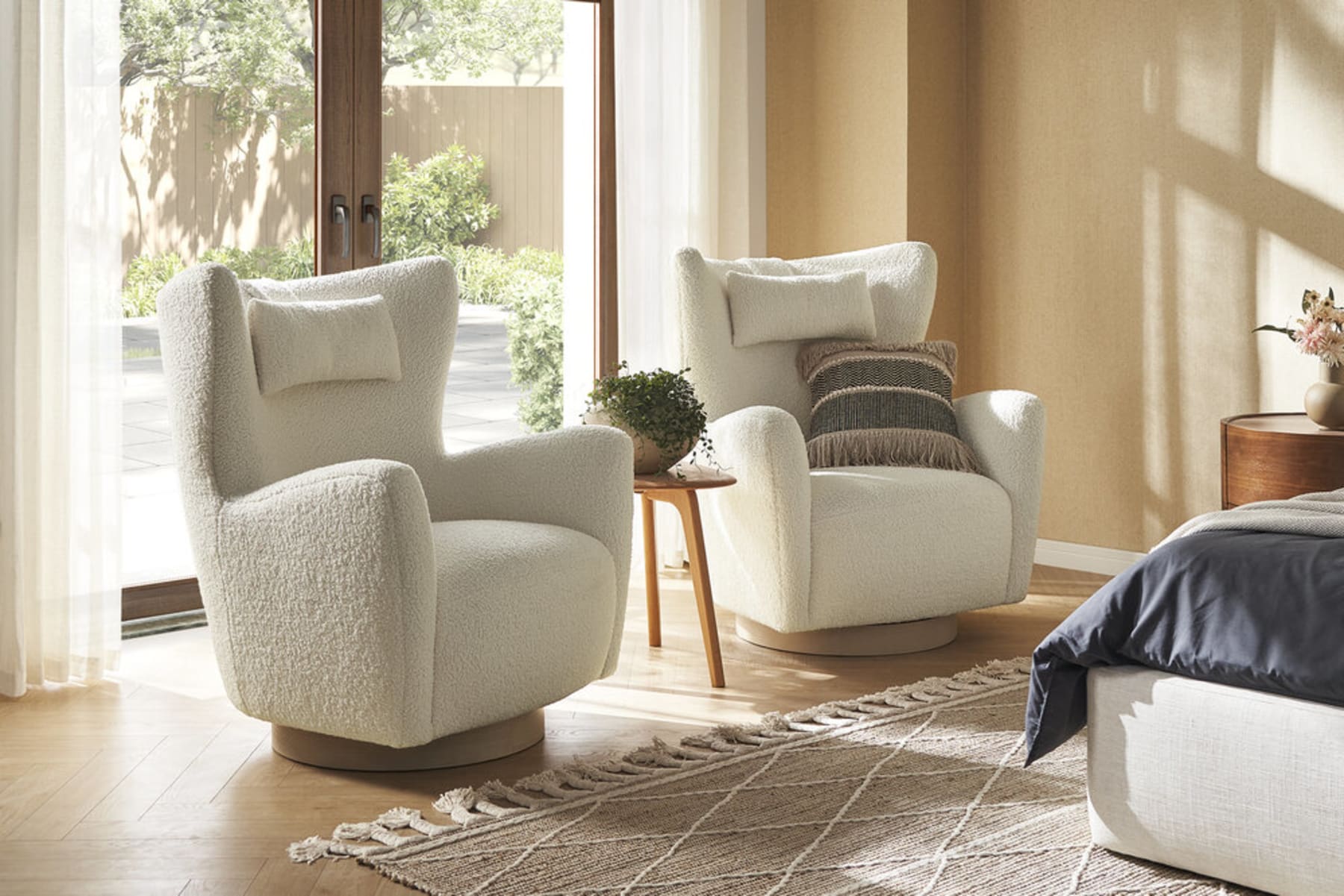 2 armchairs are placed beside the bed.