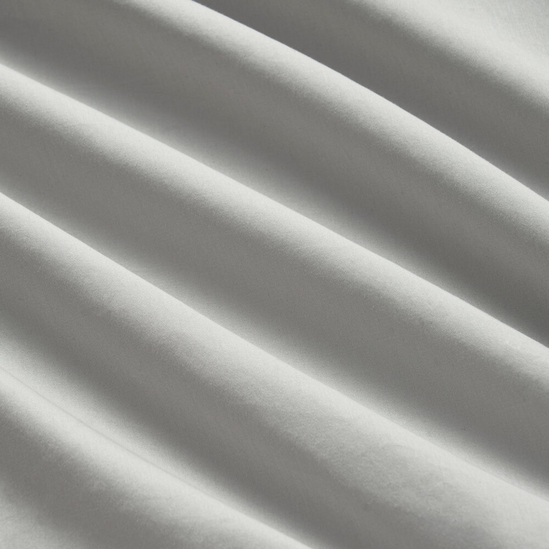 A close up shot of a gray sateen bedsheet.