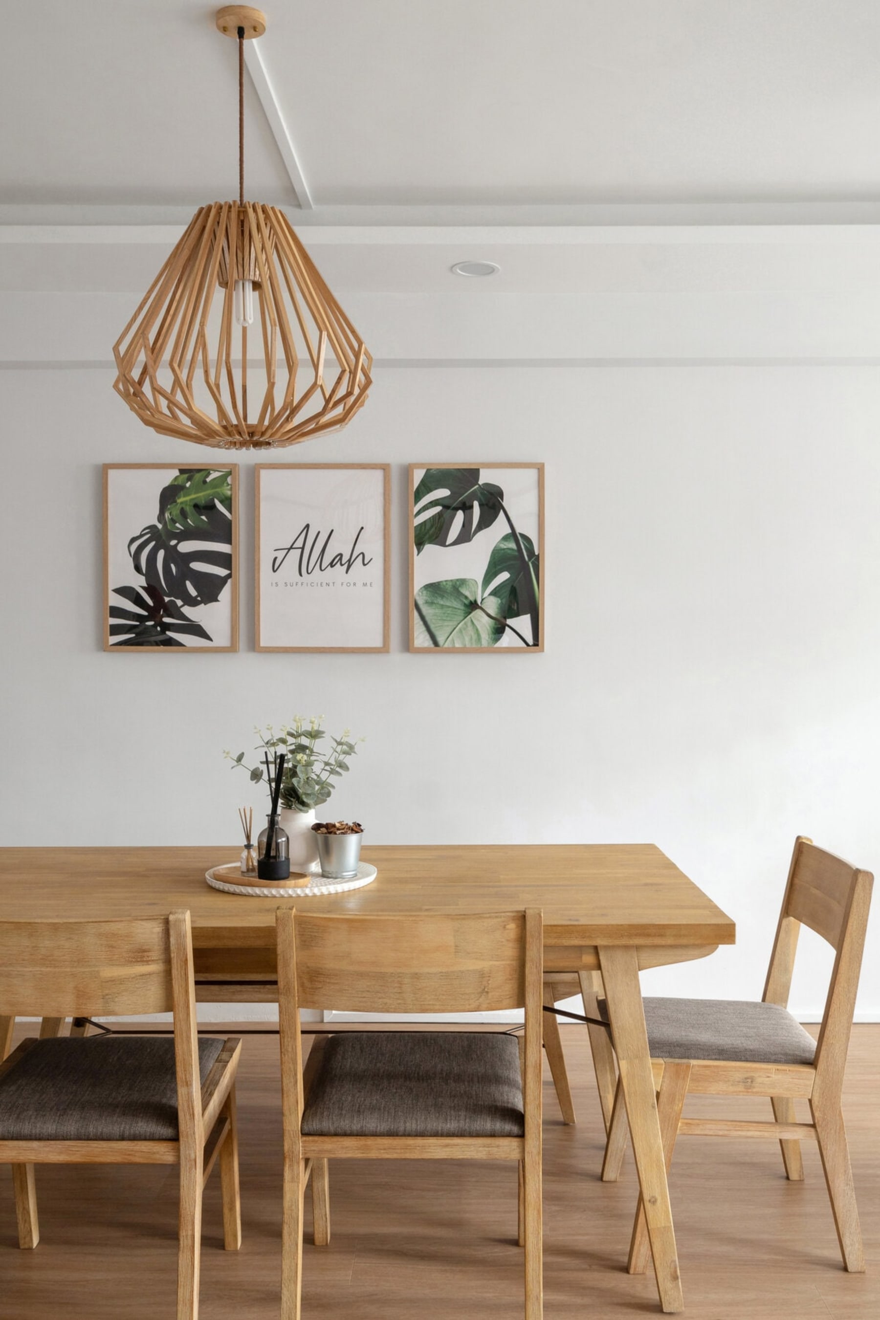 3 pieces of artwork sit above a dining table.