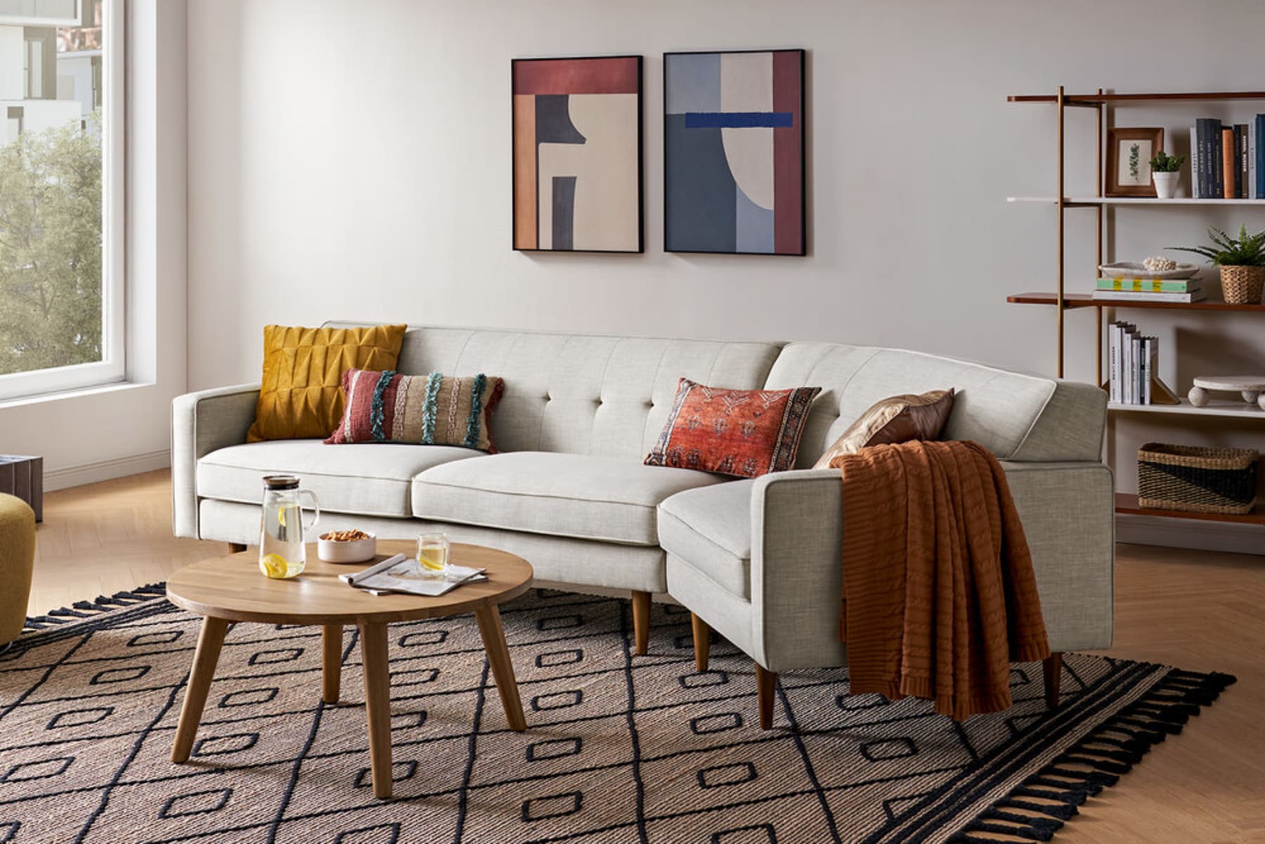 A modular sofa sits atop a jute area rug.