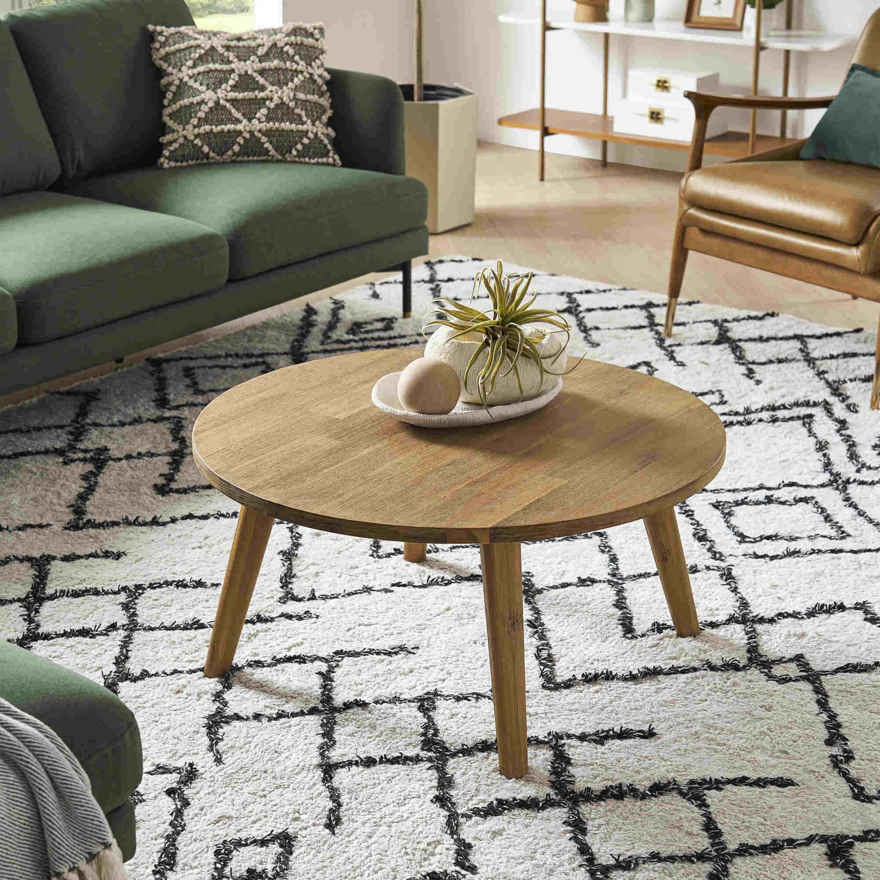 Round wooden coffee table on a geometric patterned rug