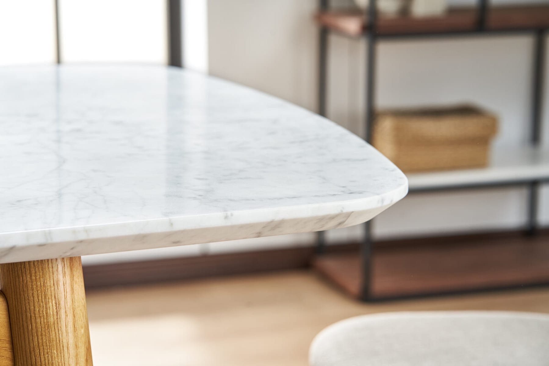 2 children are seated around a marble dining table.