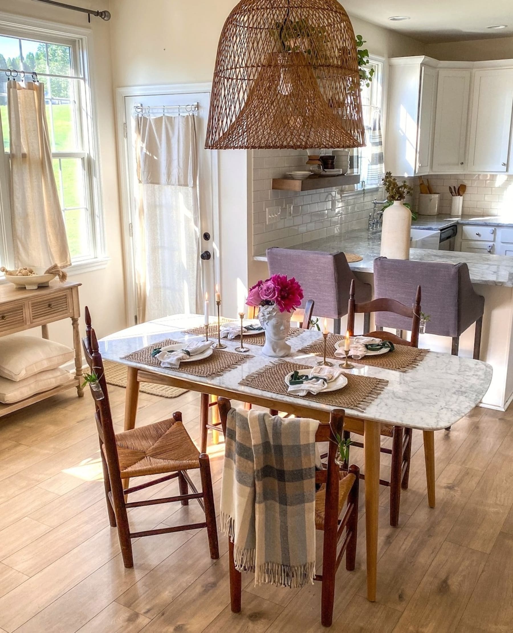 A marble dining table set with placemats and tableware.