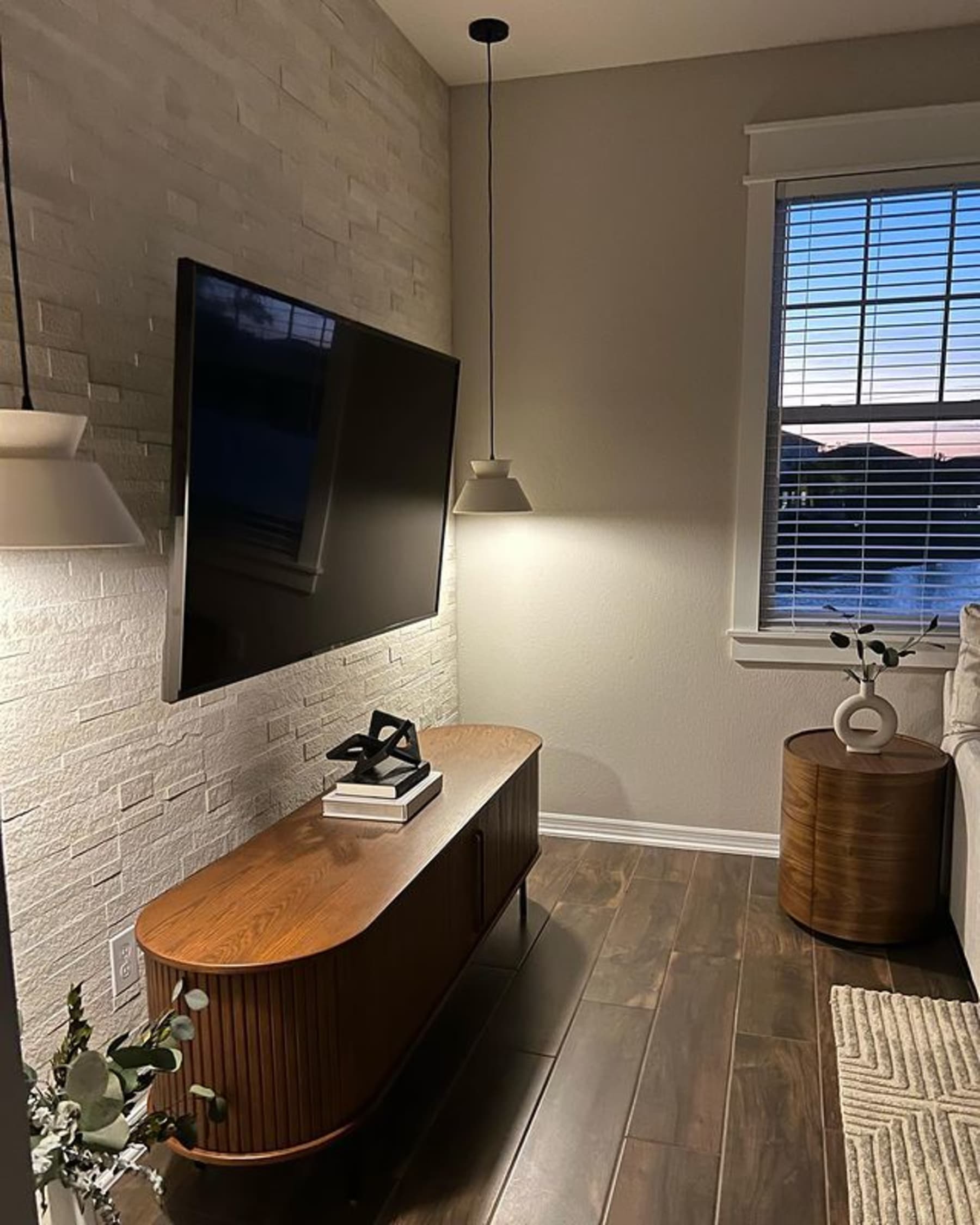 Wooden TV unit with fluted design in a dim lit living area