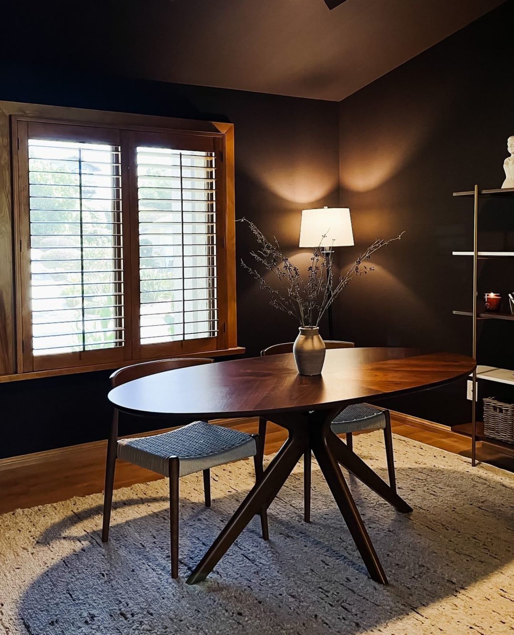 A wooden dining table with 2 chairs.