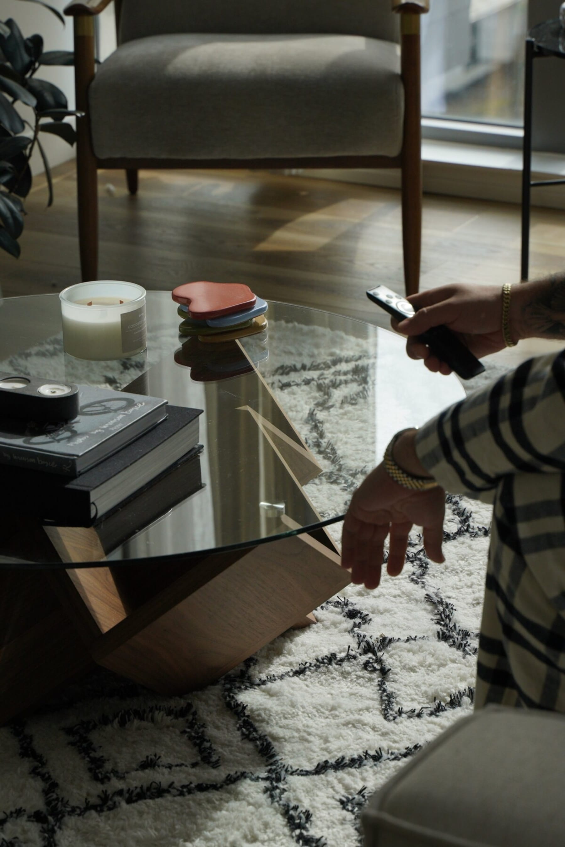 A close up shot of a glass coffee table with a sculptural base.