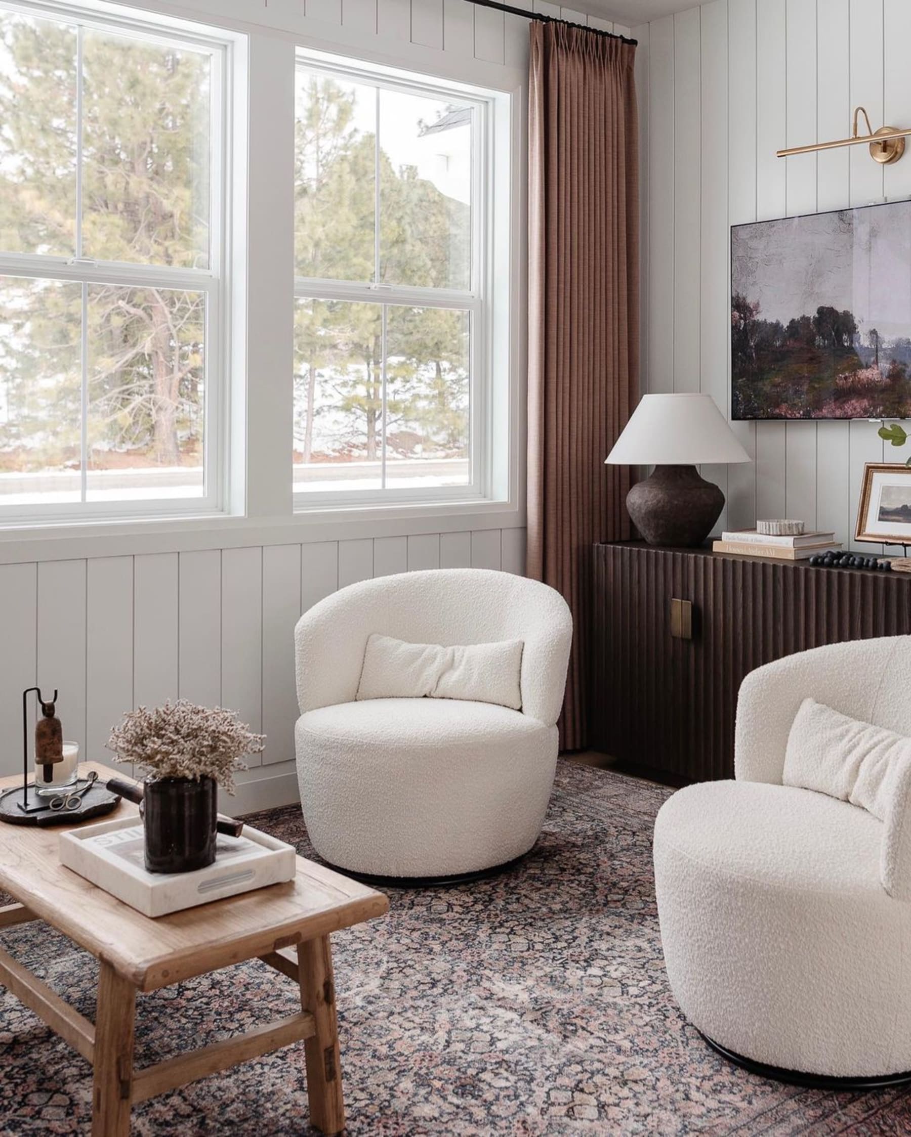 Two bouclé armchairs placed next to each other in a living room.