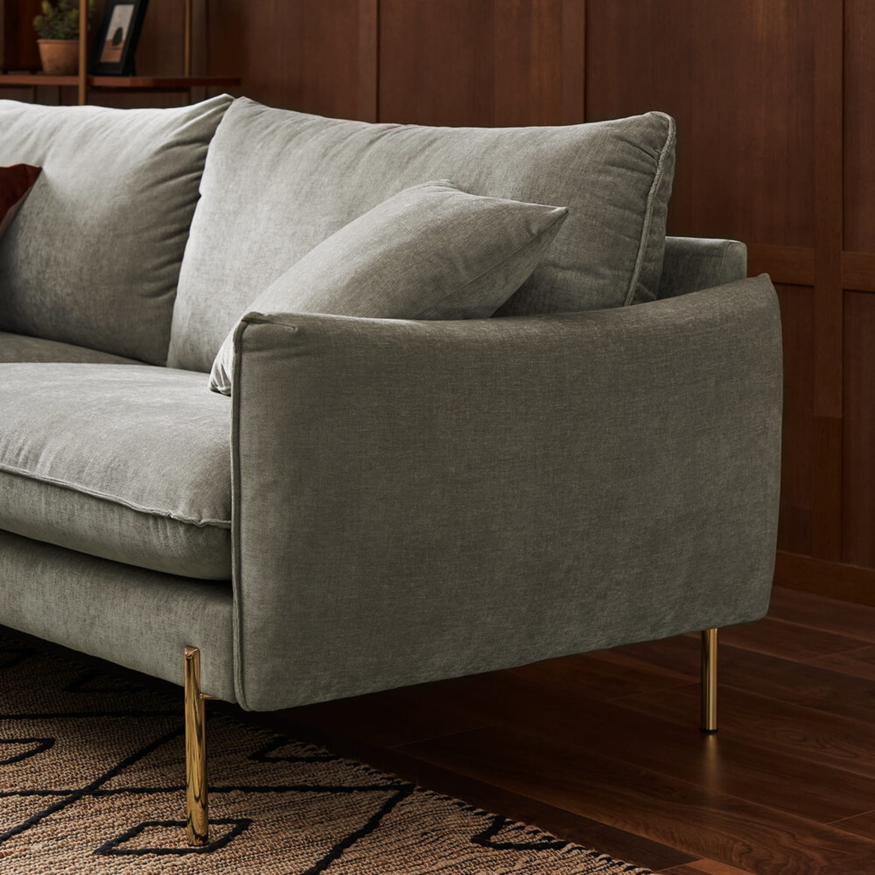 A close up shot of a fabric sofa with metal legs.