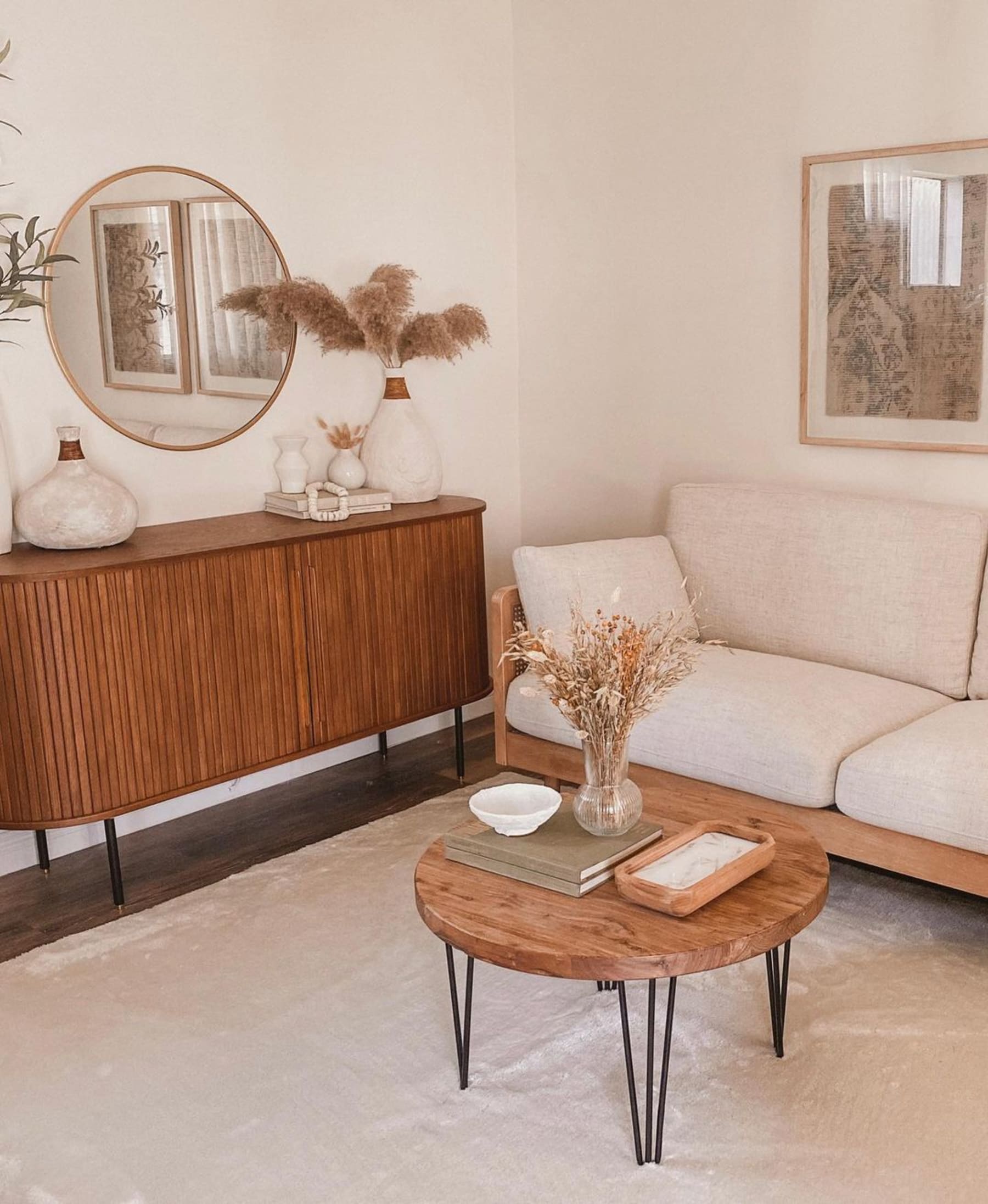 A wooden sideboard, a sofa with a wooden frame, and a wooden coffee table.