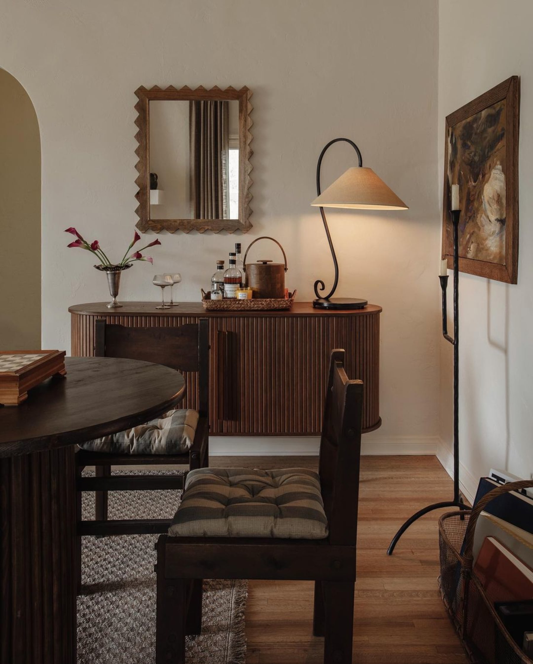 A sideboard with a lamp perched on top.