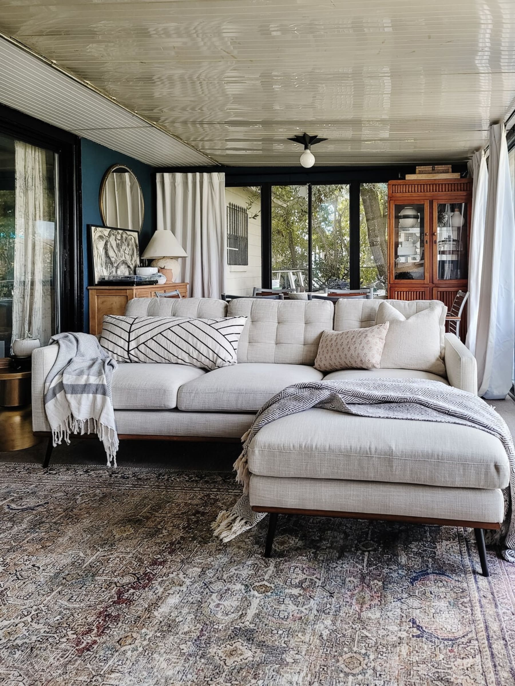 A reversible sectional sofa with tufted backrests.