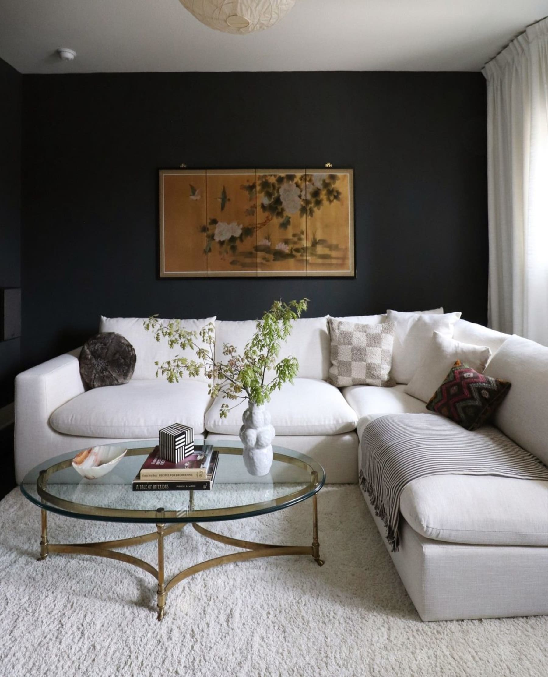 A gray sectional sofa with different textured pillows.