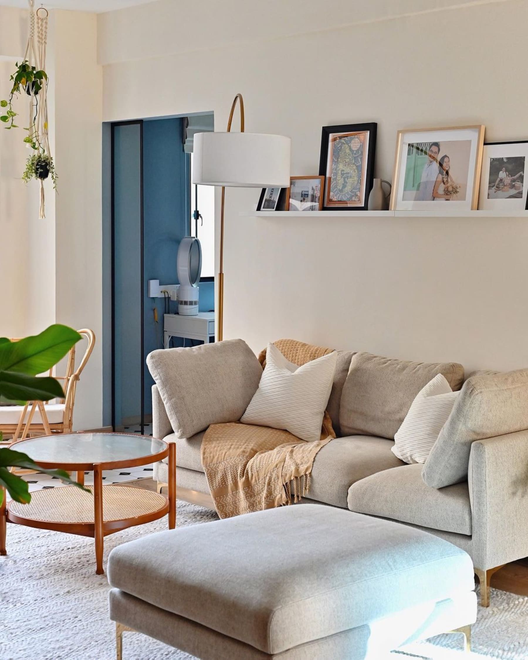 A sofa and matching ottoman set with a throw draped over the sofa.