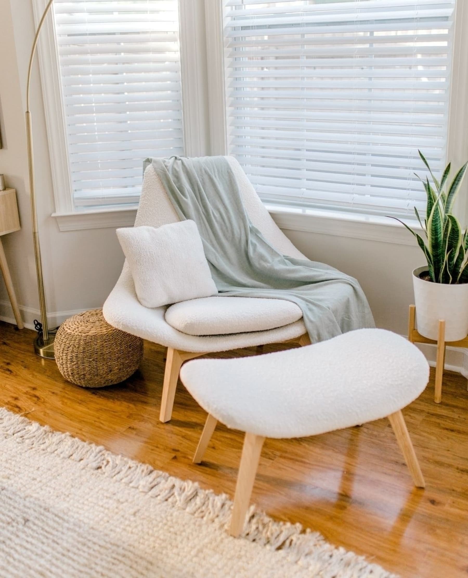 A performance bouclé armchair with a matching footstool.