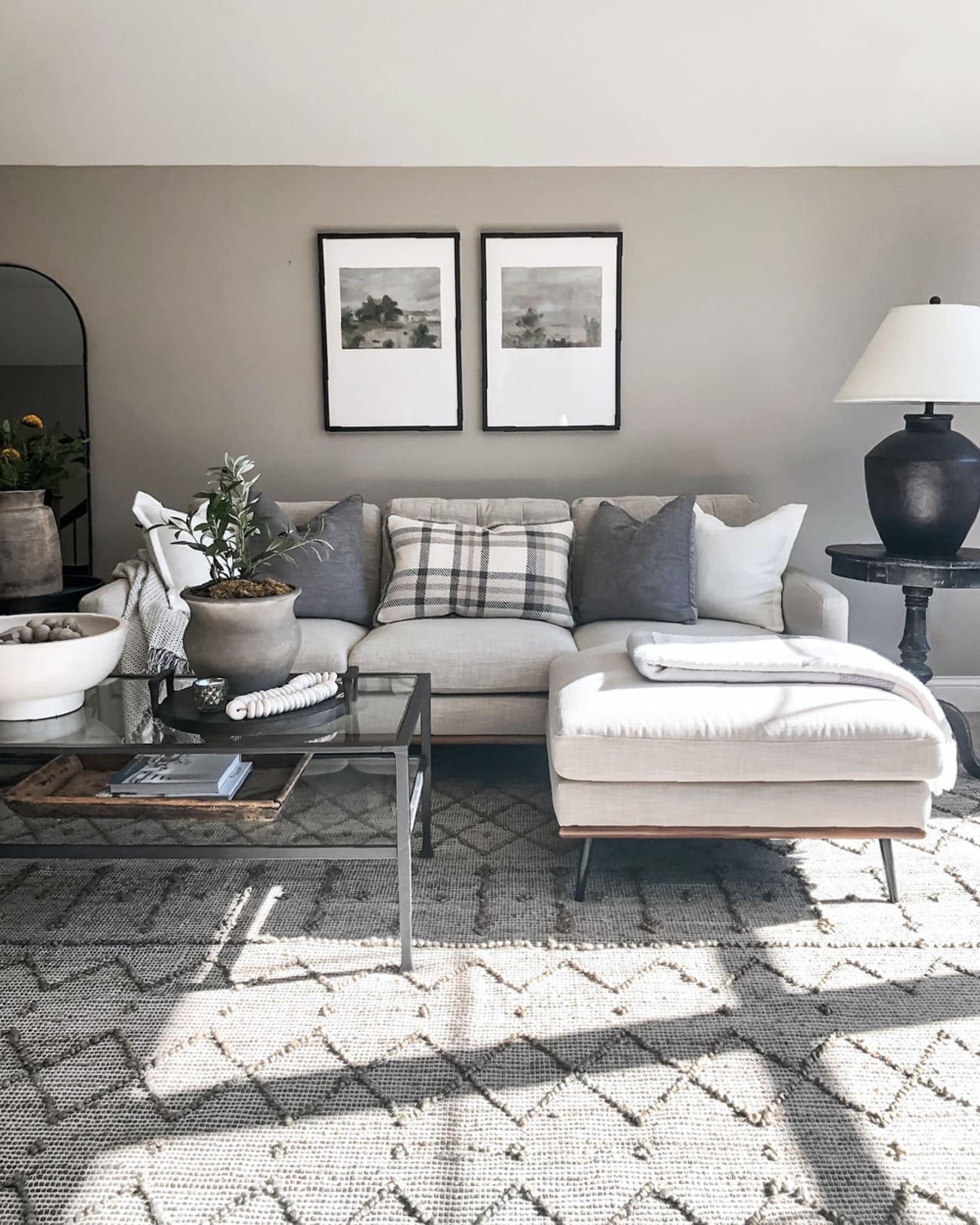 A sectional sofa with cushions placed symmetrically.