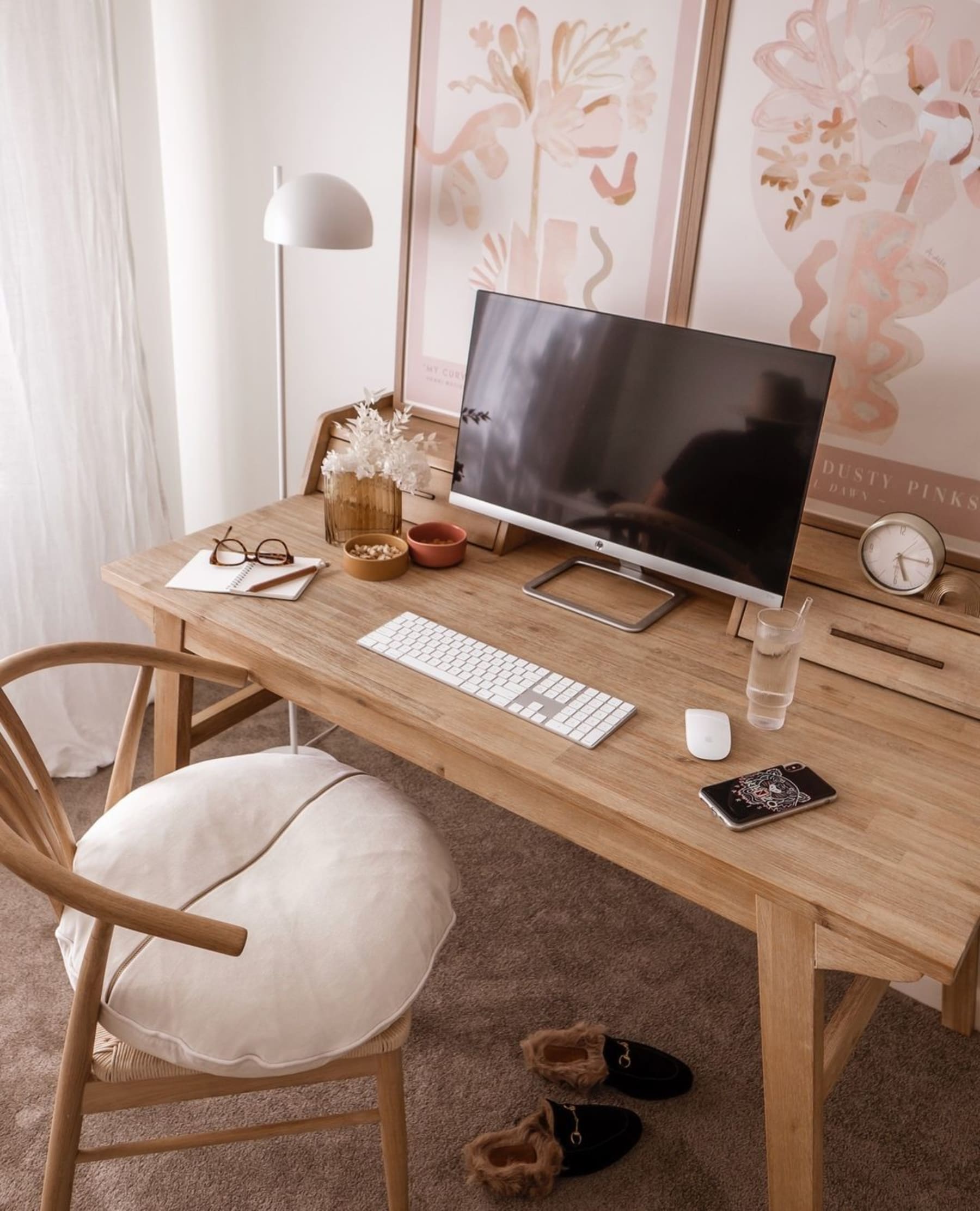 A wooden desk with a computer and keyboard atop.