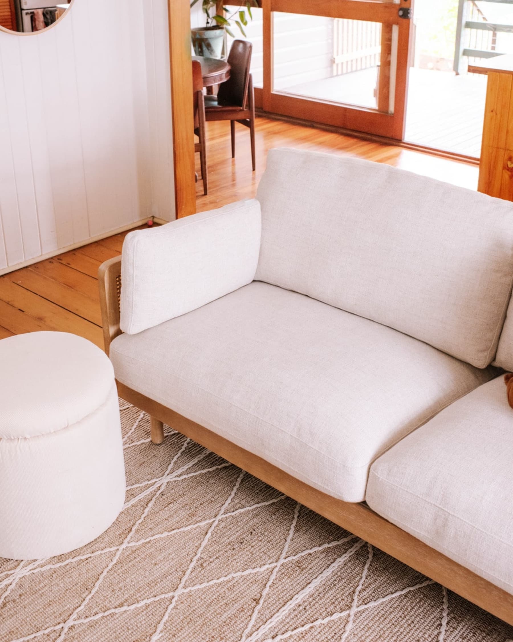 A jute area rug anchors a cane sofa in the living room.