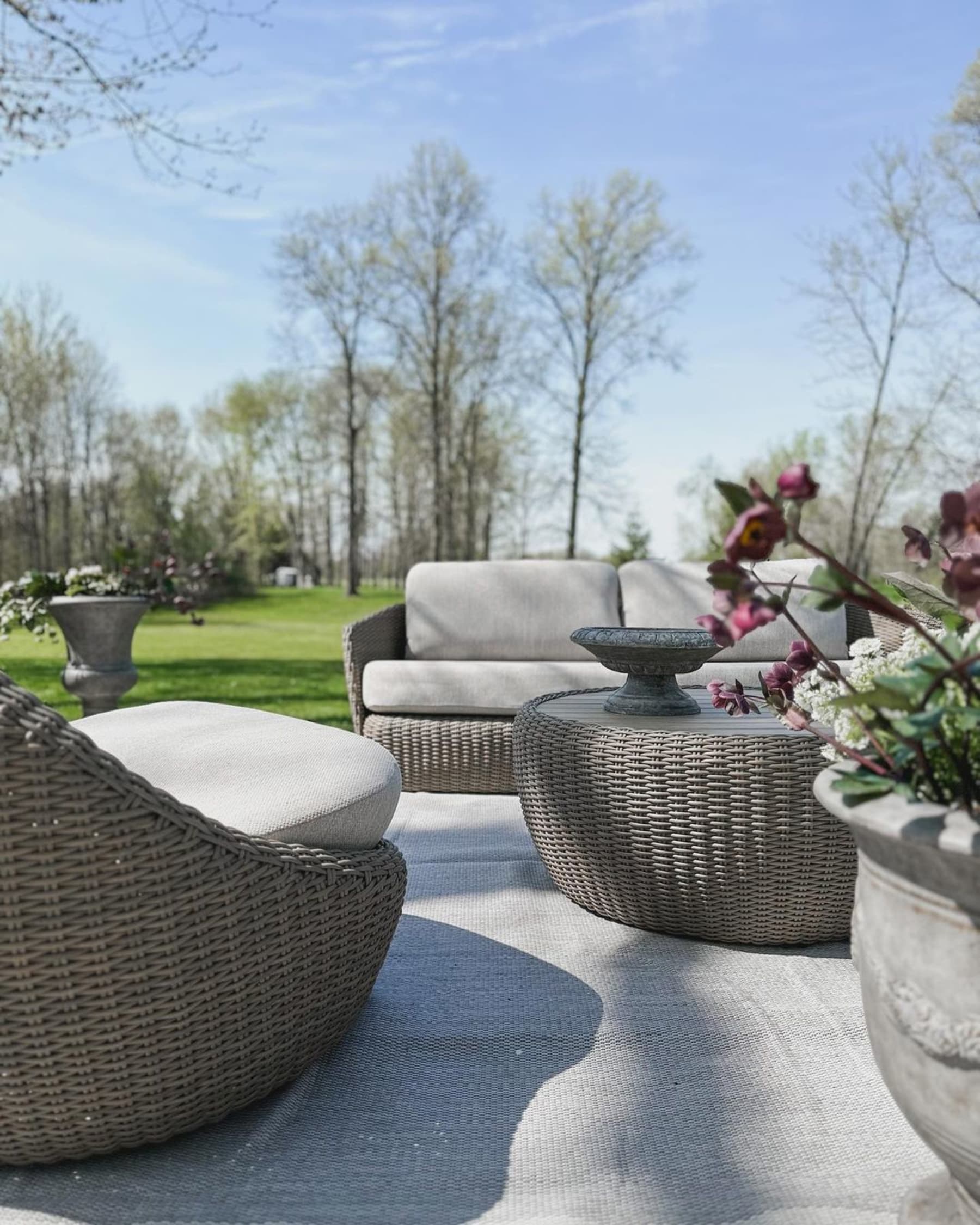 A wicker loveseat, lounge chair, and coffee table.