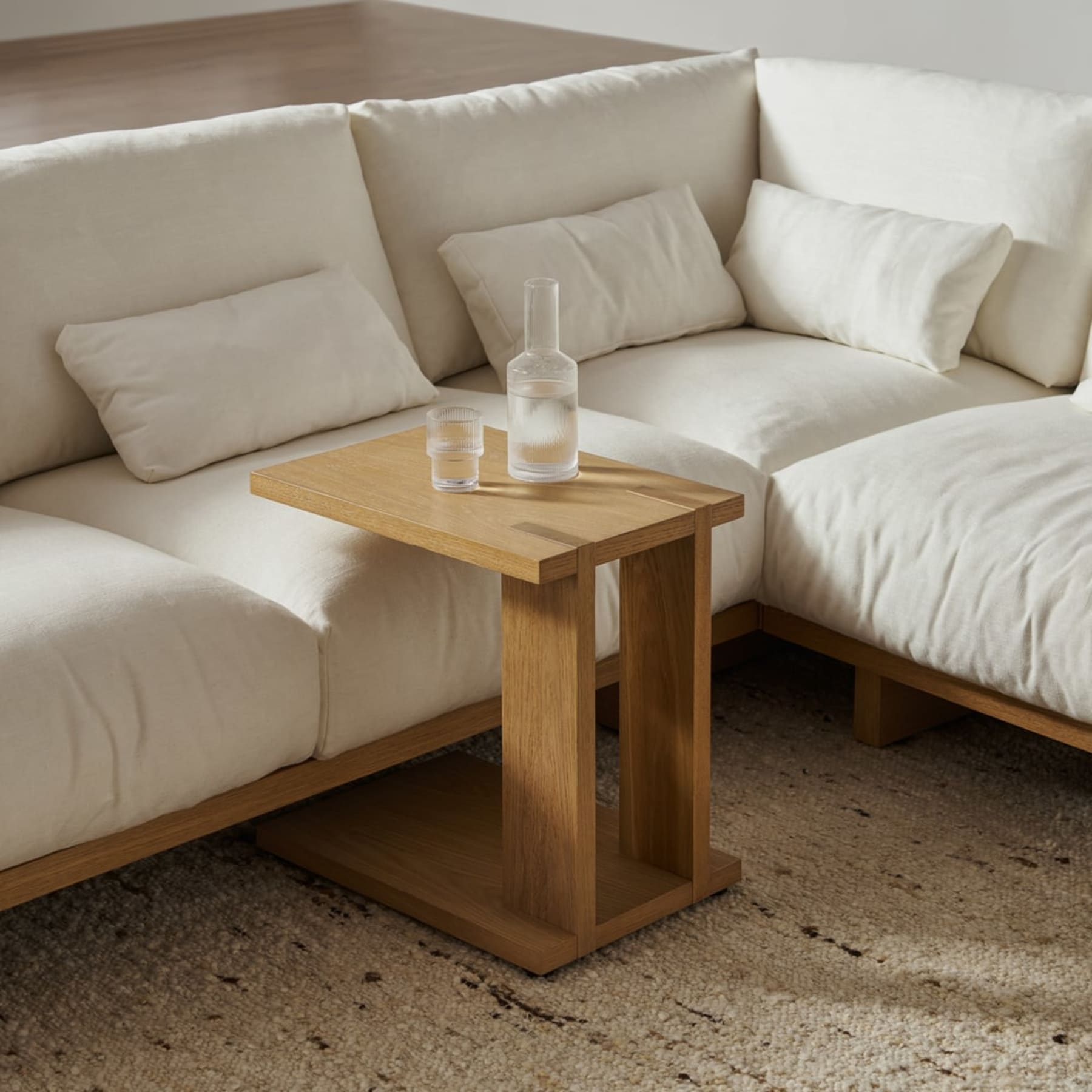 A c-side table with a glass and bottle of water.