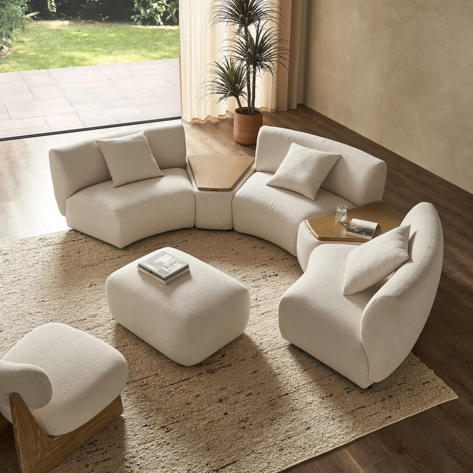 A modular curved sofa and 2 wedged storage consoles.