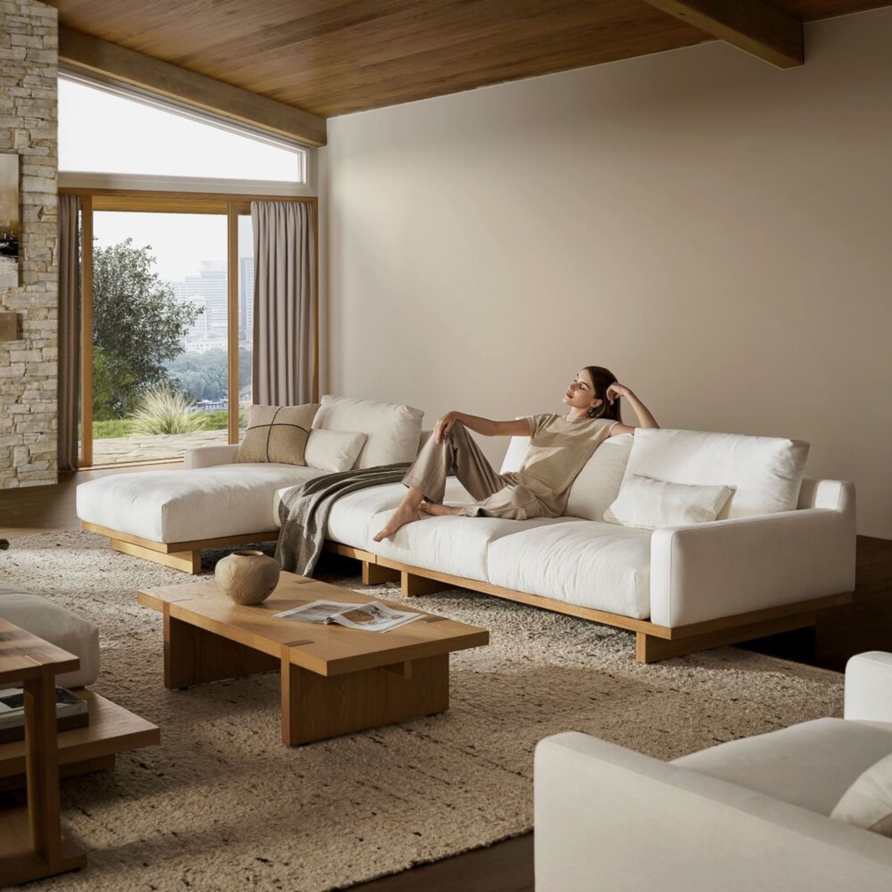 An asymmetrical performance bouclé sofa in a living room with brown hues.