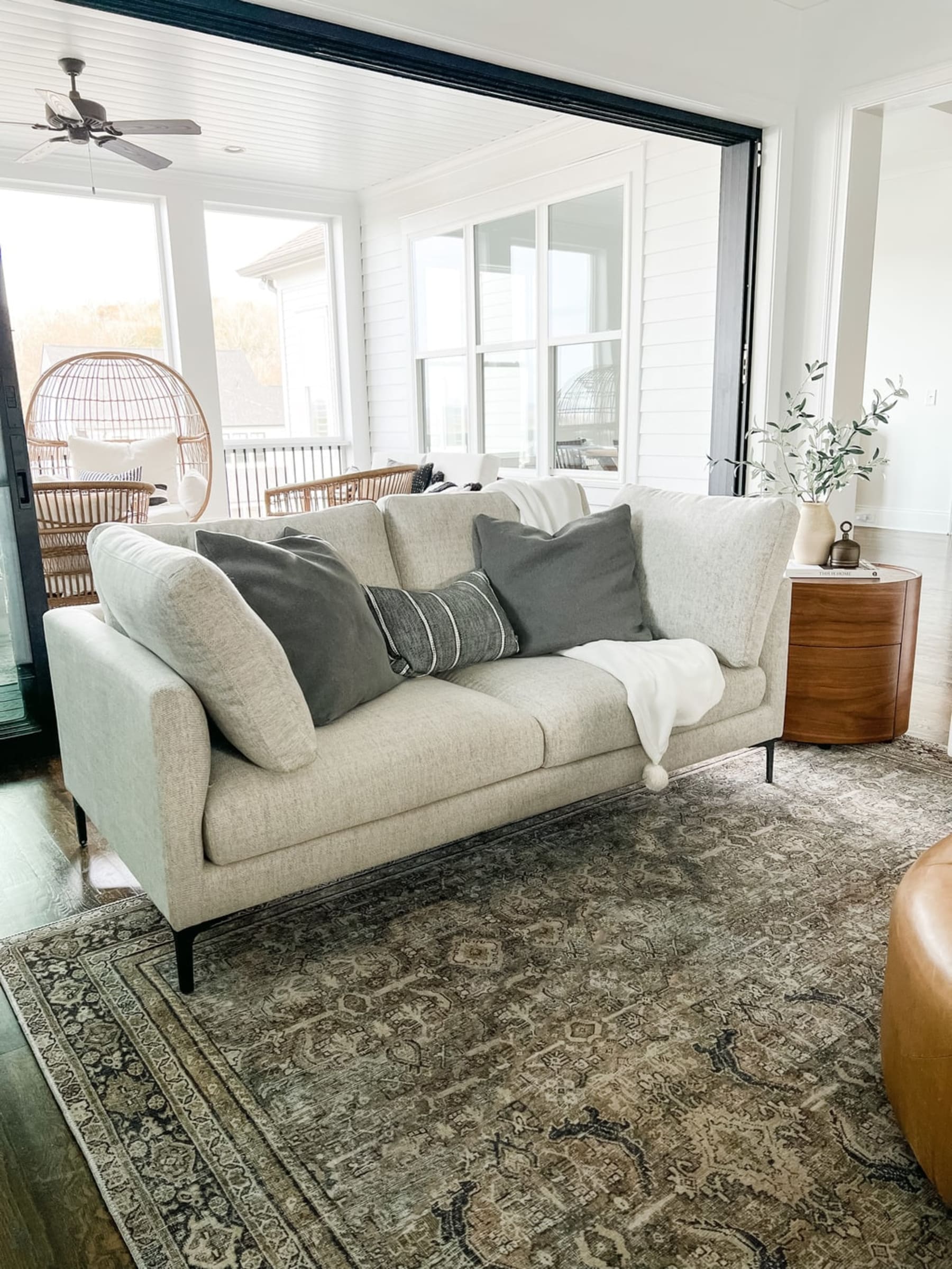 A loveseat with pillows arranged symmetrically.