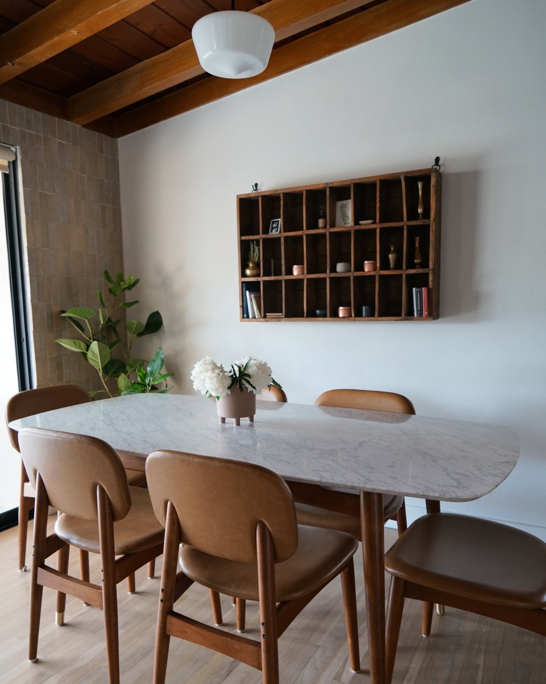 A marble dining table with matching leather dining chairs.