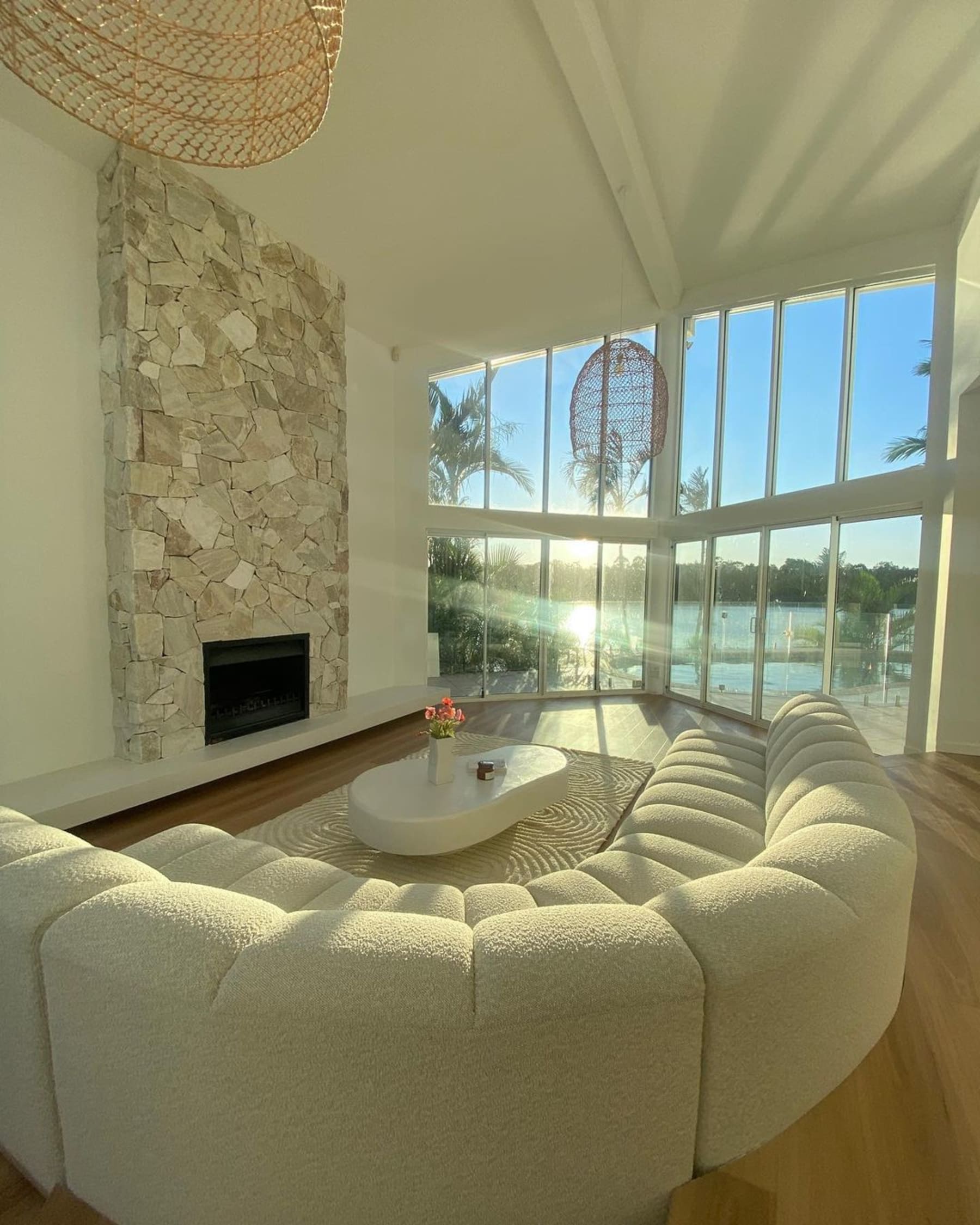 A performance bouclé chaise sectional sofa in the middle of a large living room.