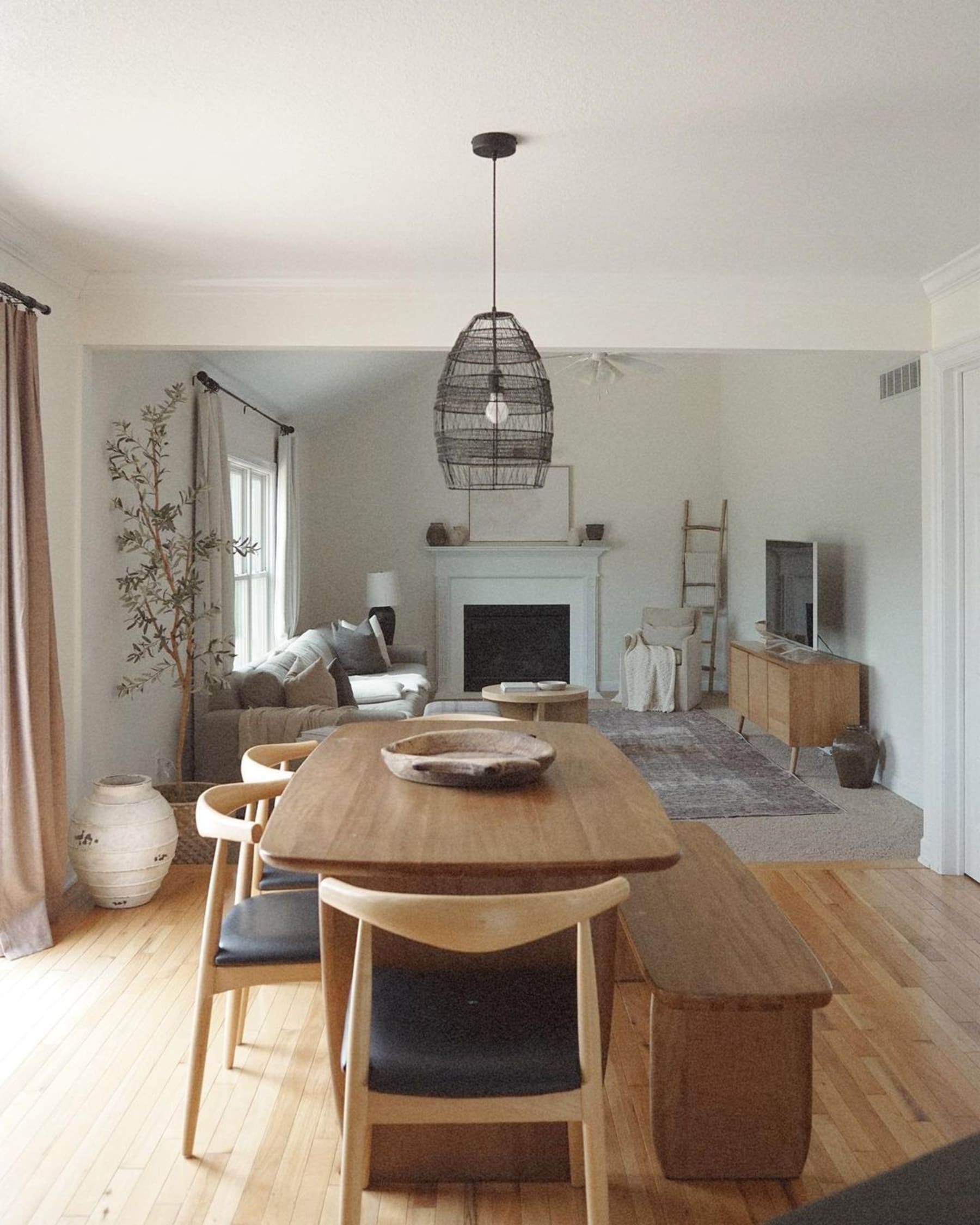 A wooden dining table with four chairs and a bench.