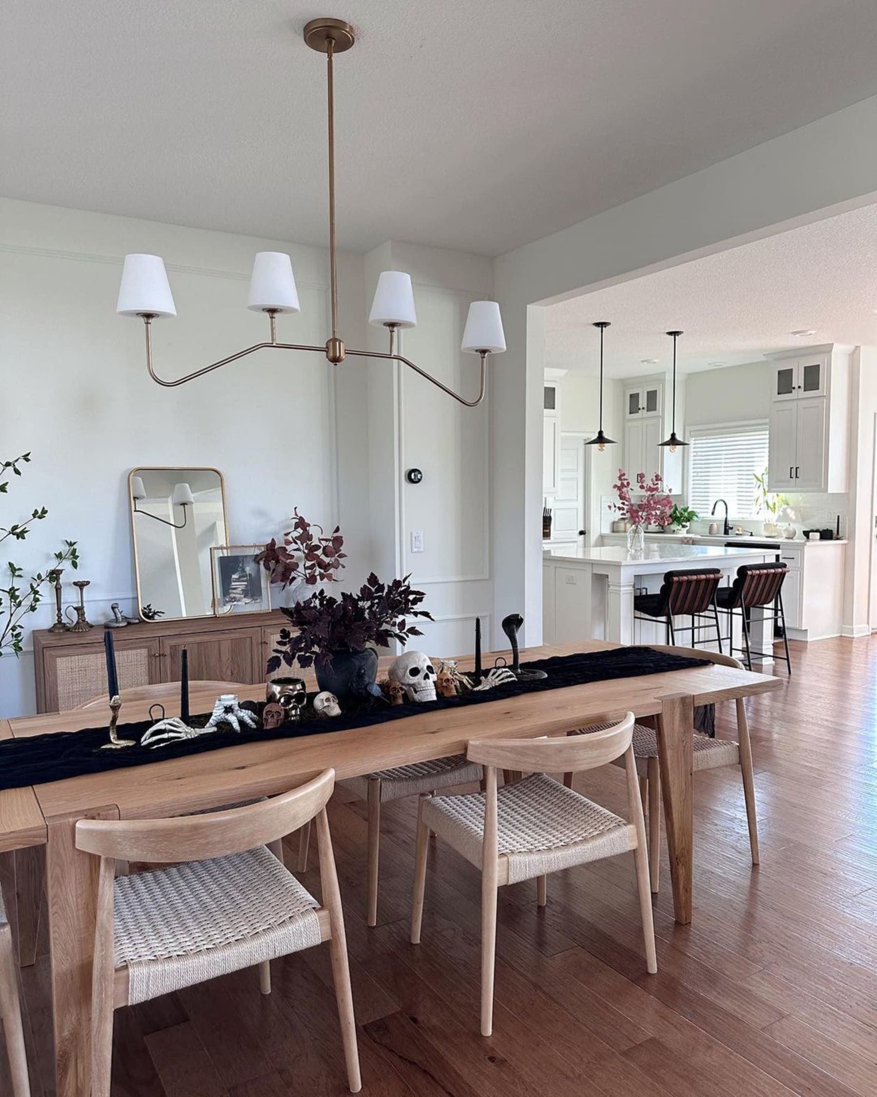 A wooden dining table with 6 black chairs.