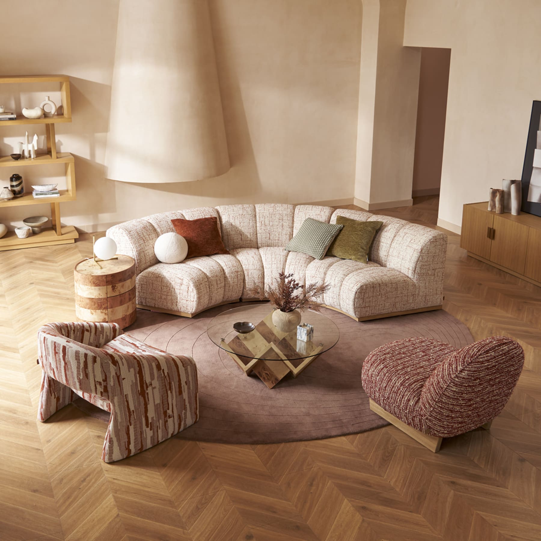 A curved sofa, two armchairs, coffee table, and a side table in a living room.