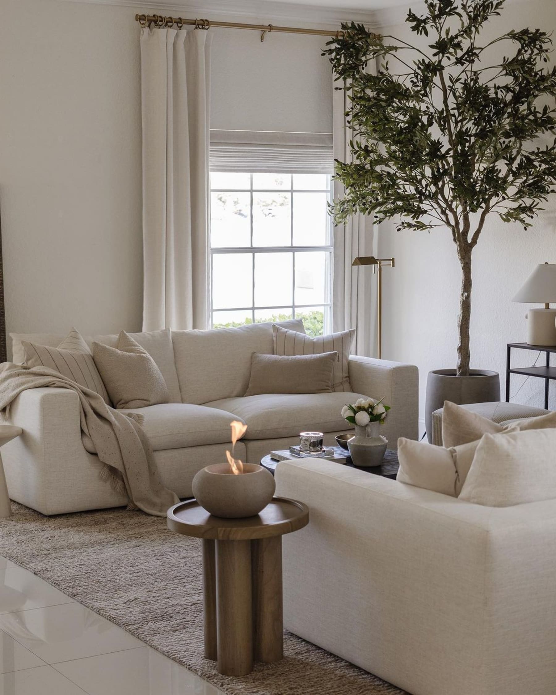 Two matching white 3-seater sofas placed opposite each other in a living room